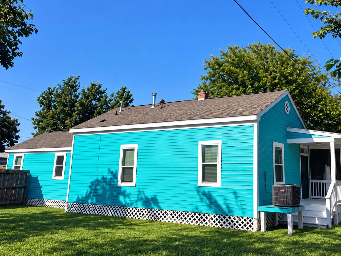 Vibrant turquoise siding exterior with white trim