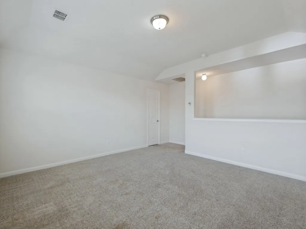 Carpeted flooring, neutral wall paint, recessed lighting, and a white paneled door