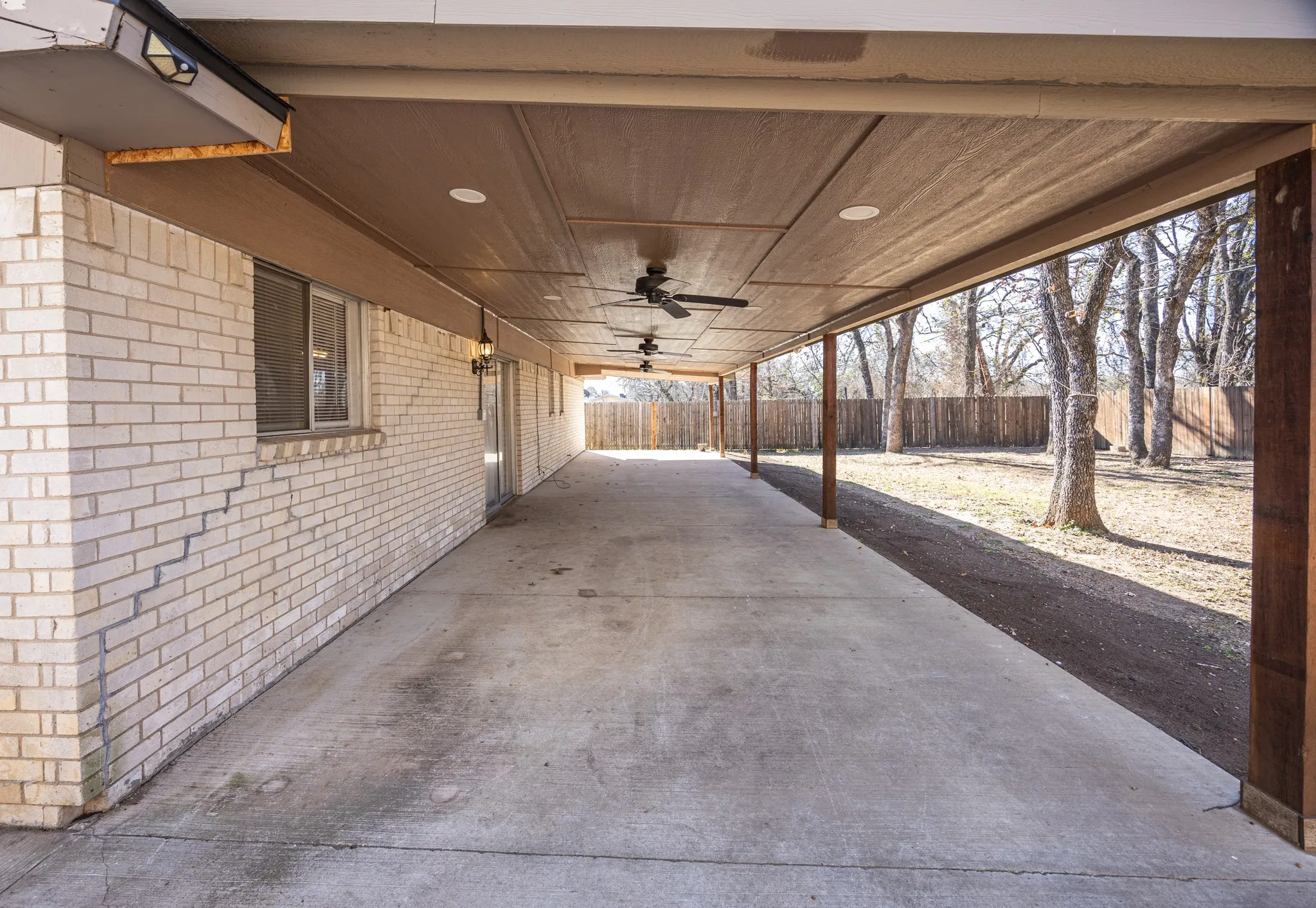 View of patio with ceiling fans