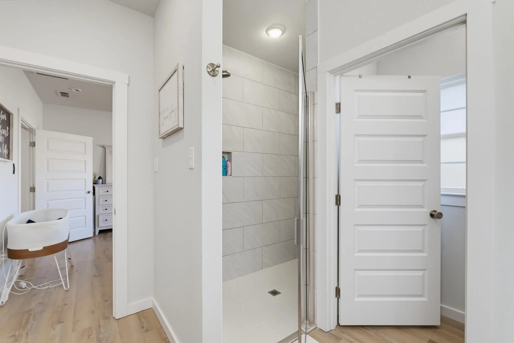 Walk-in shower with tiled walls and glass enclosure