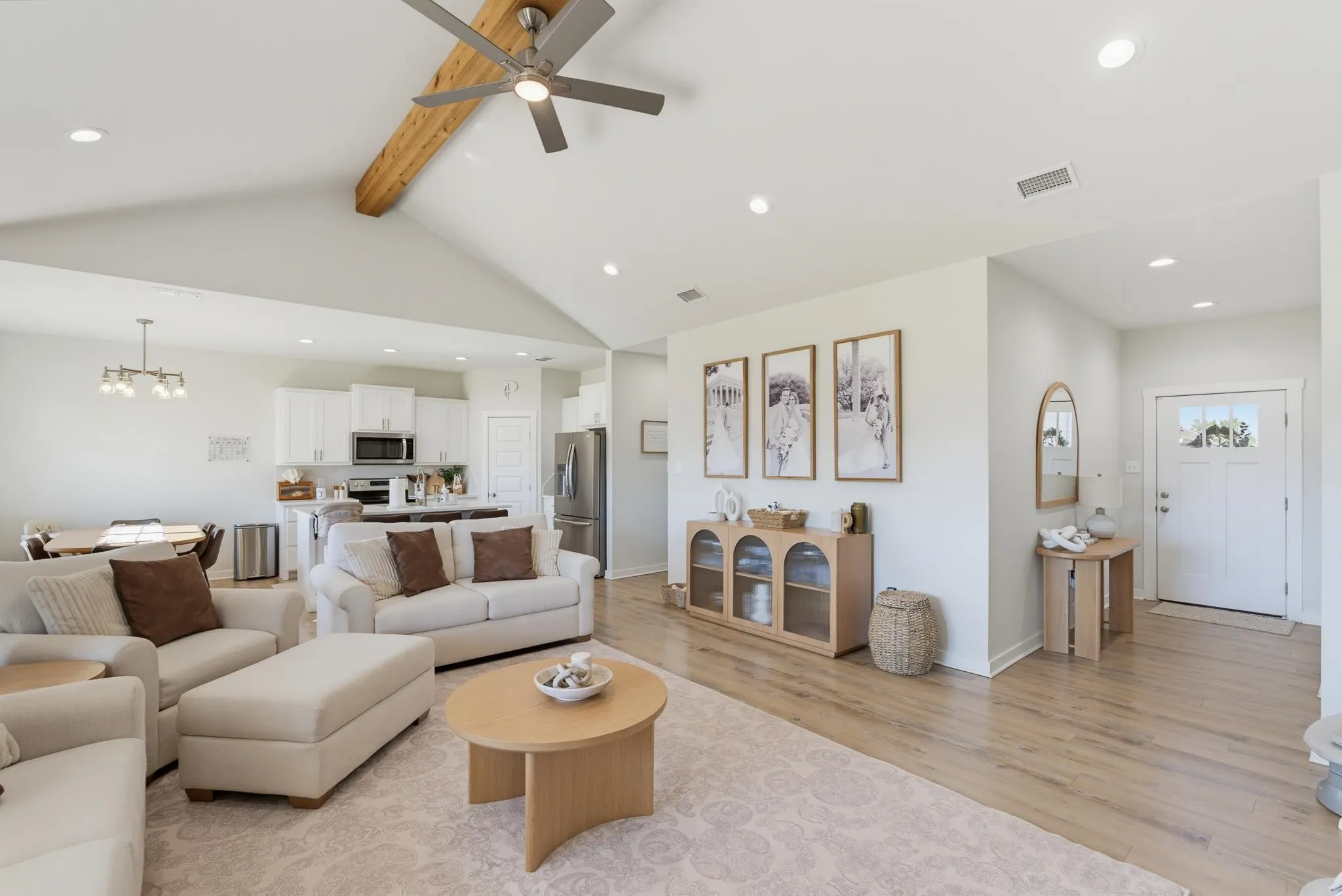 Vaulted ceiling with an exposed wood beam, recessed lighting, wood-finish flooring, and a ceiling fan