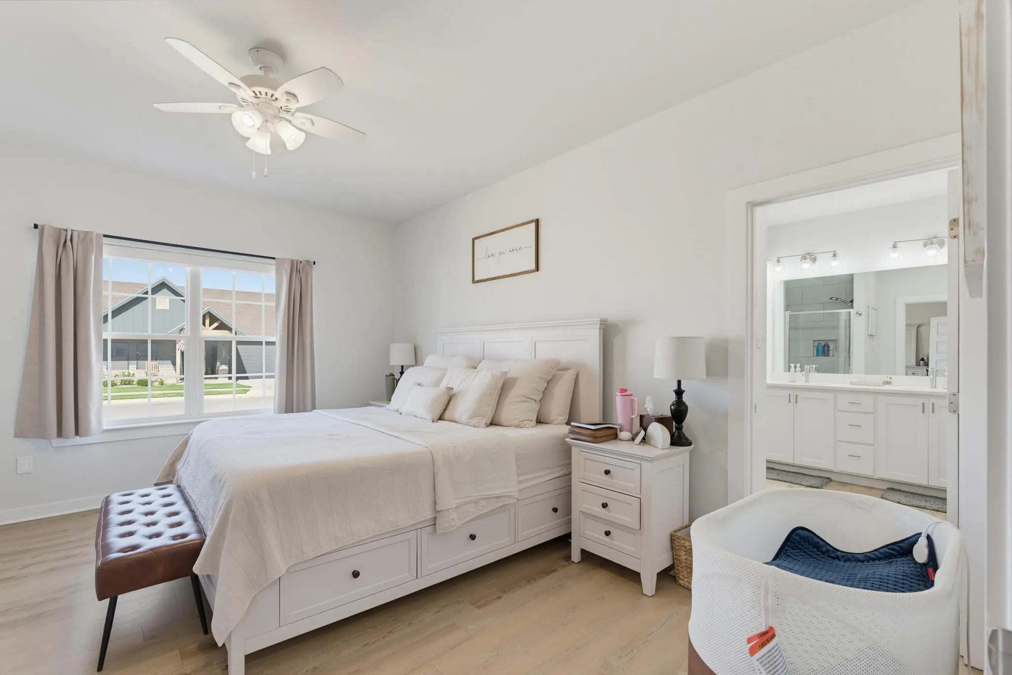 Bright room featuring wood-finish flooring, a ceiling fan with integrated lighting, and a large window