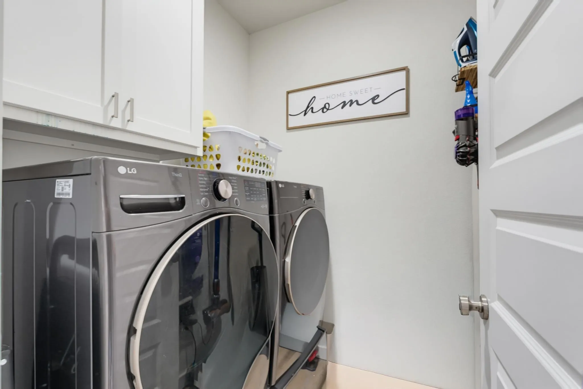 White shaker-style cabinetry with chrome hardware