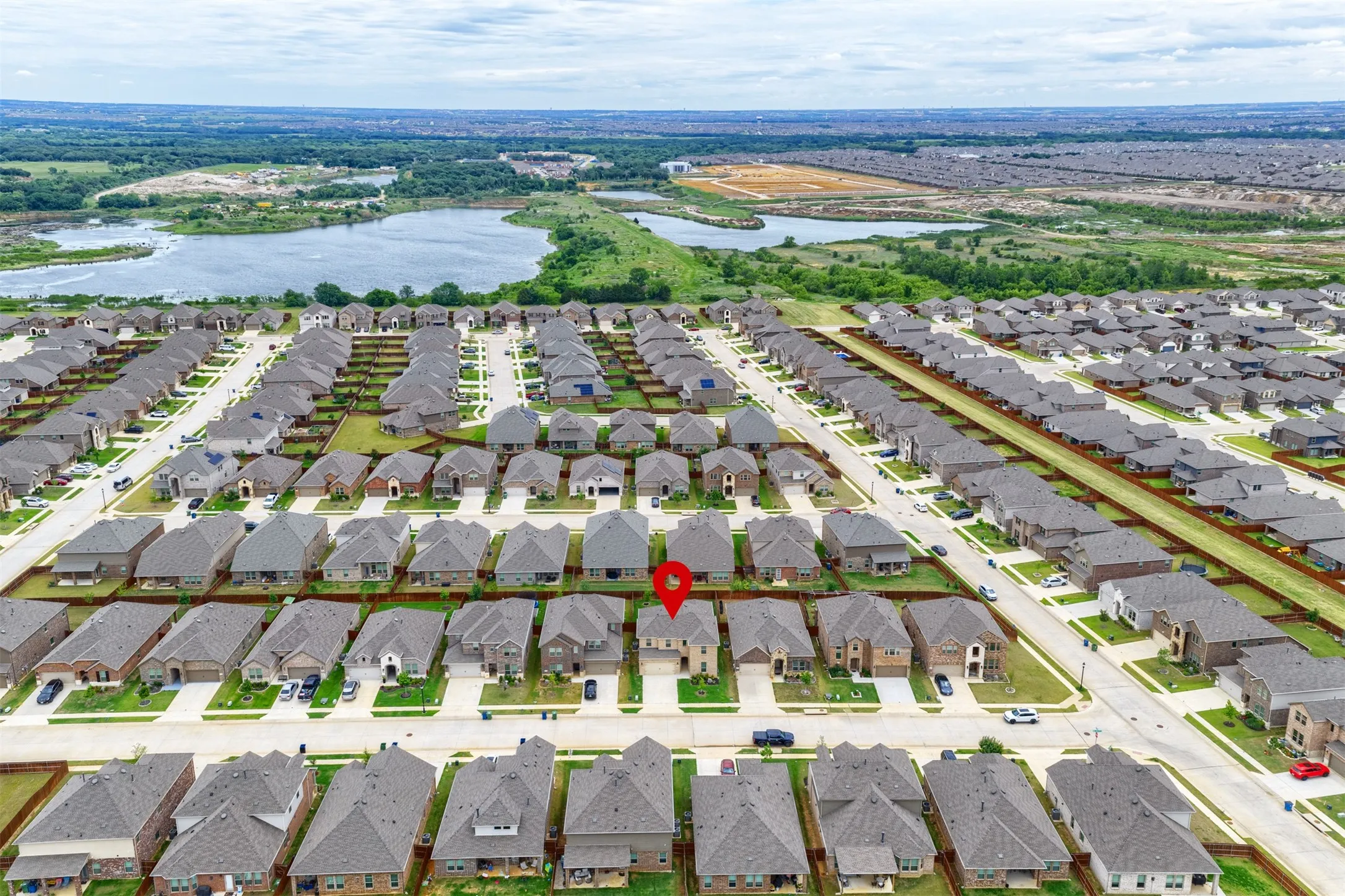 Aerial perspective of a developed residential area with a prominent water feature