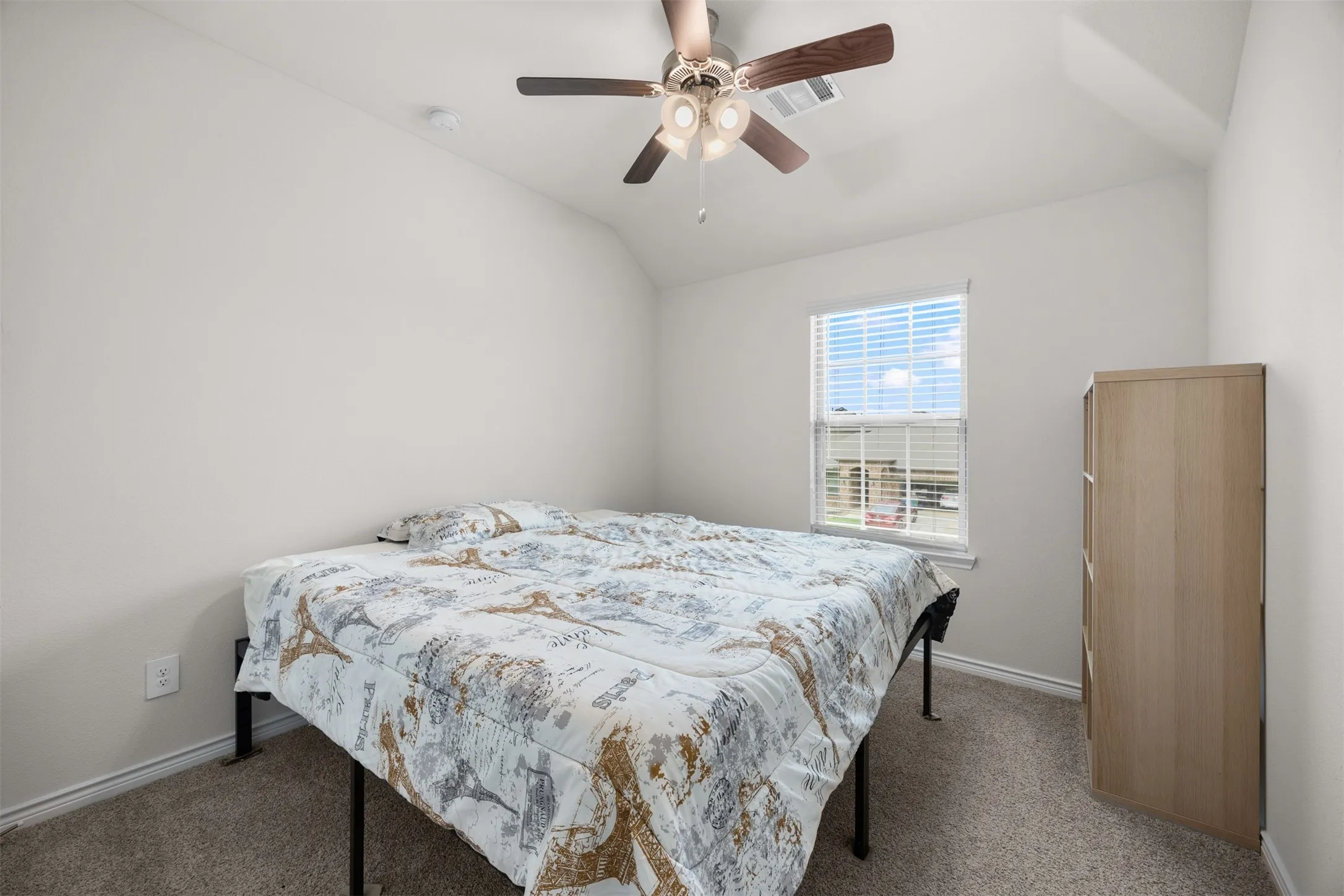 Carpeted room featuring a ceiling fan with integrated lighting, a single window with blinds, and white painted walls