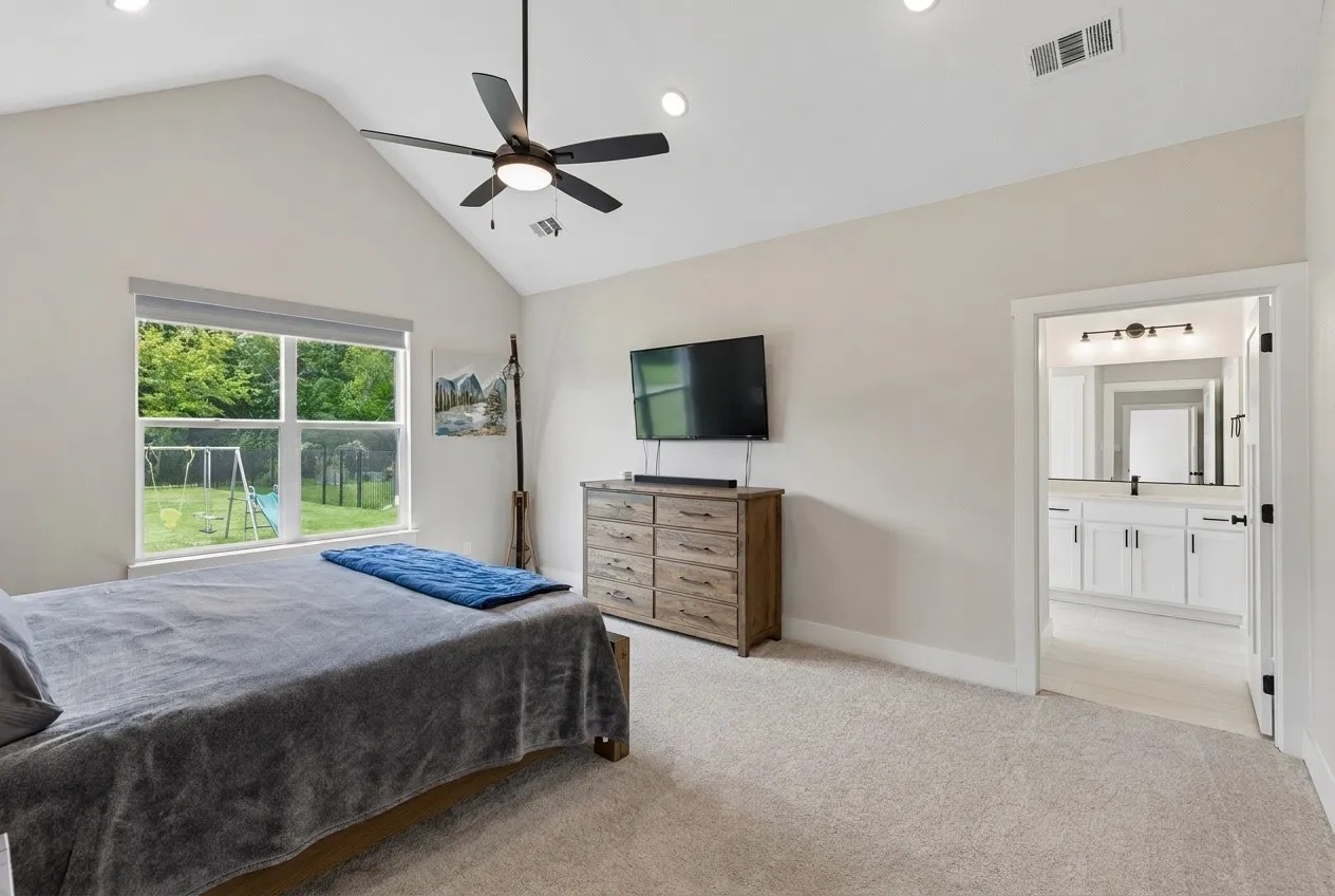 Vaulted ceiling with a ceiling fan, recessed lighting, and soft carpet flooring