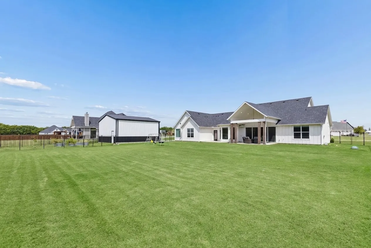 Separately fenced garden area behind detached RV garage.