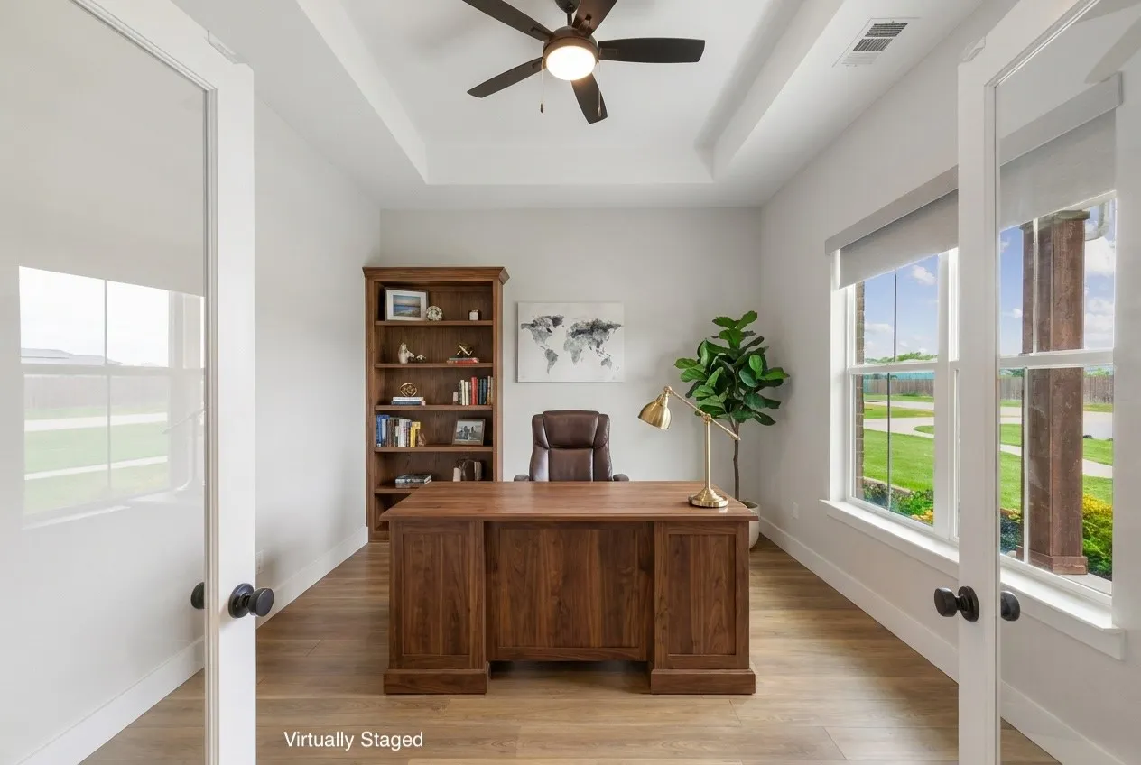 Tray ceiling with a ceiling fan, wood-finish LVP flooring, and white trim. This has been virtually staged.