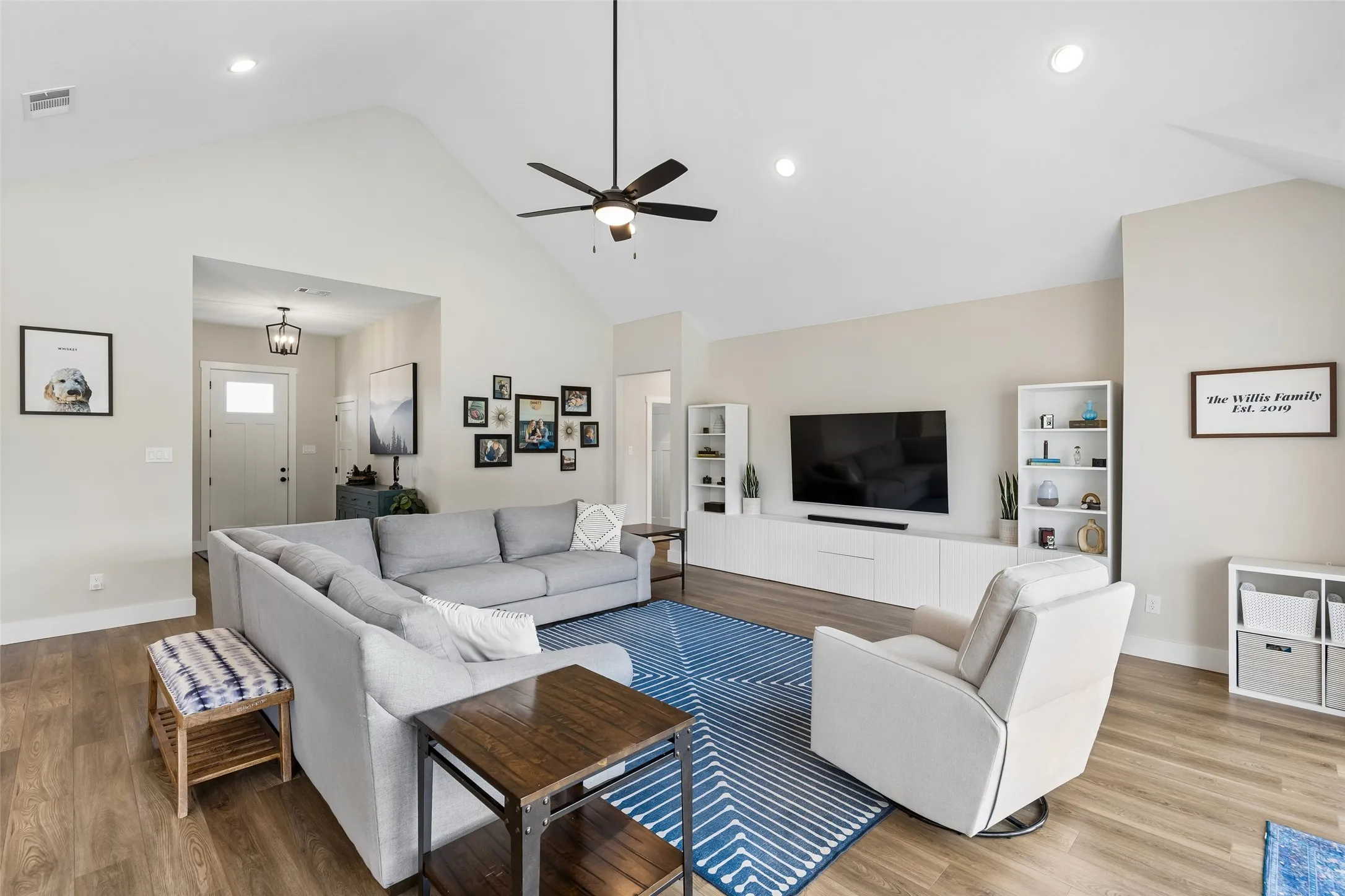 Vaulted ceiling with a ceiling fan, recessed lighting, and wood-finish LVP flooring