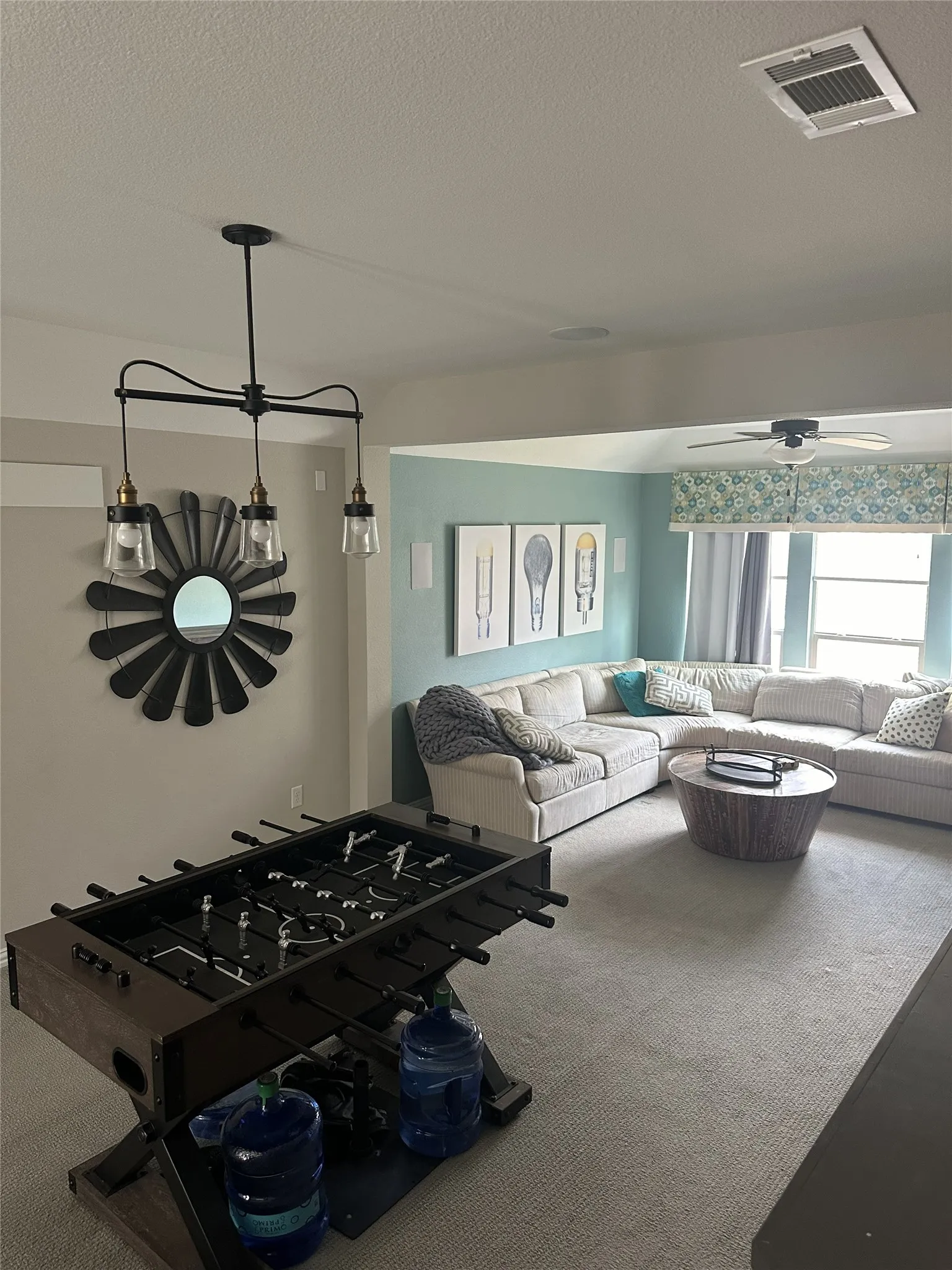 Recessed ceiling lighting, ceiling fan, carpet flooring, and a decorative wall mirror