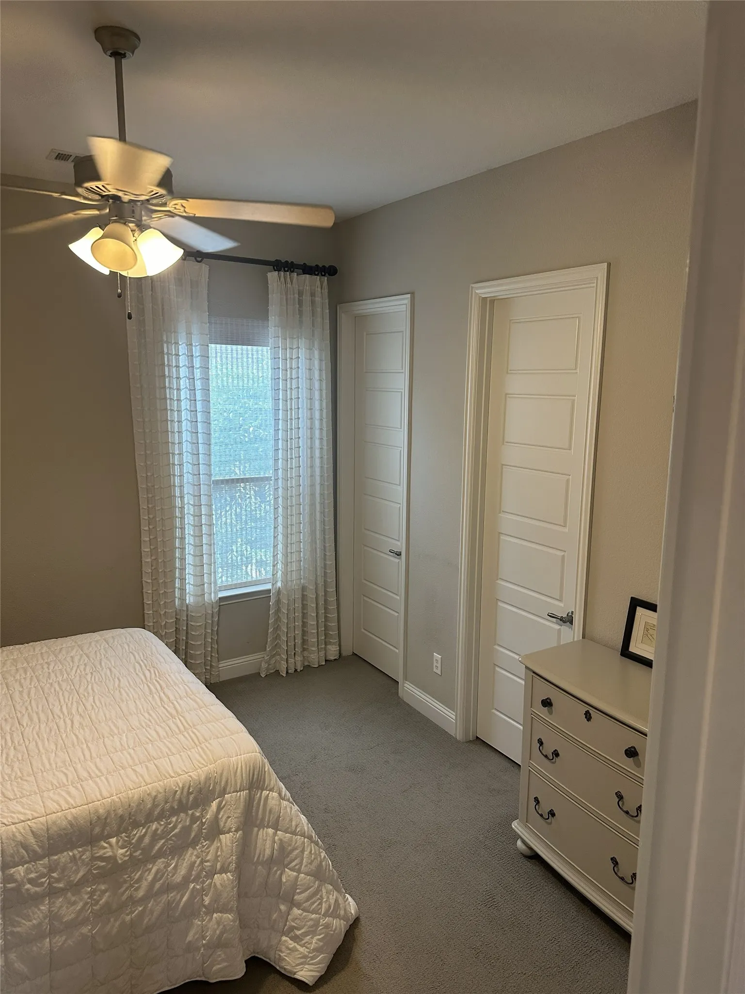 Recessed lighting, ceiling fan with light fixture, gray wall paint, paneled interior doors, and carpeted flooring