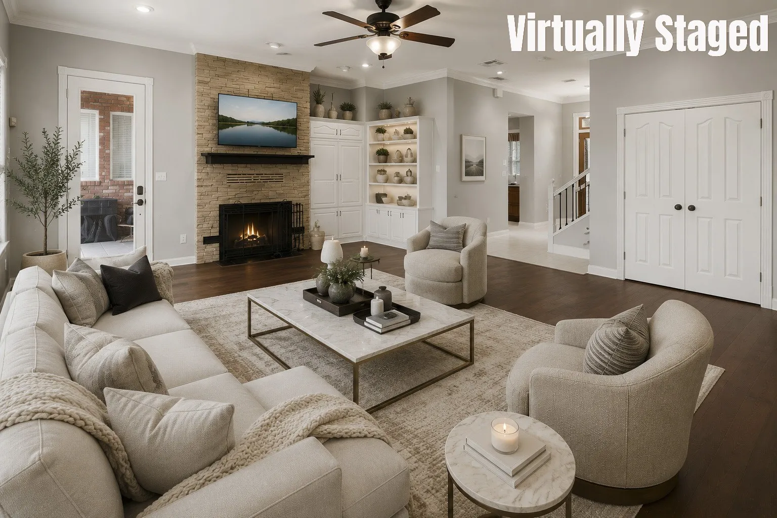 Spacious living area featuring a stone-clad fireplace, integrated shelving with recessed lighting, and dark engineered hard wood flooring