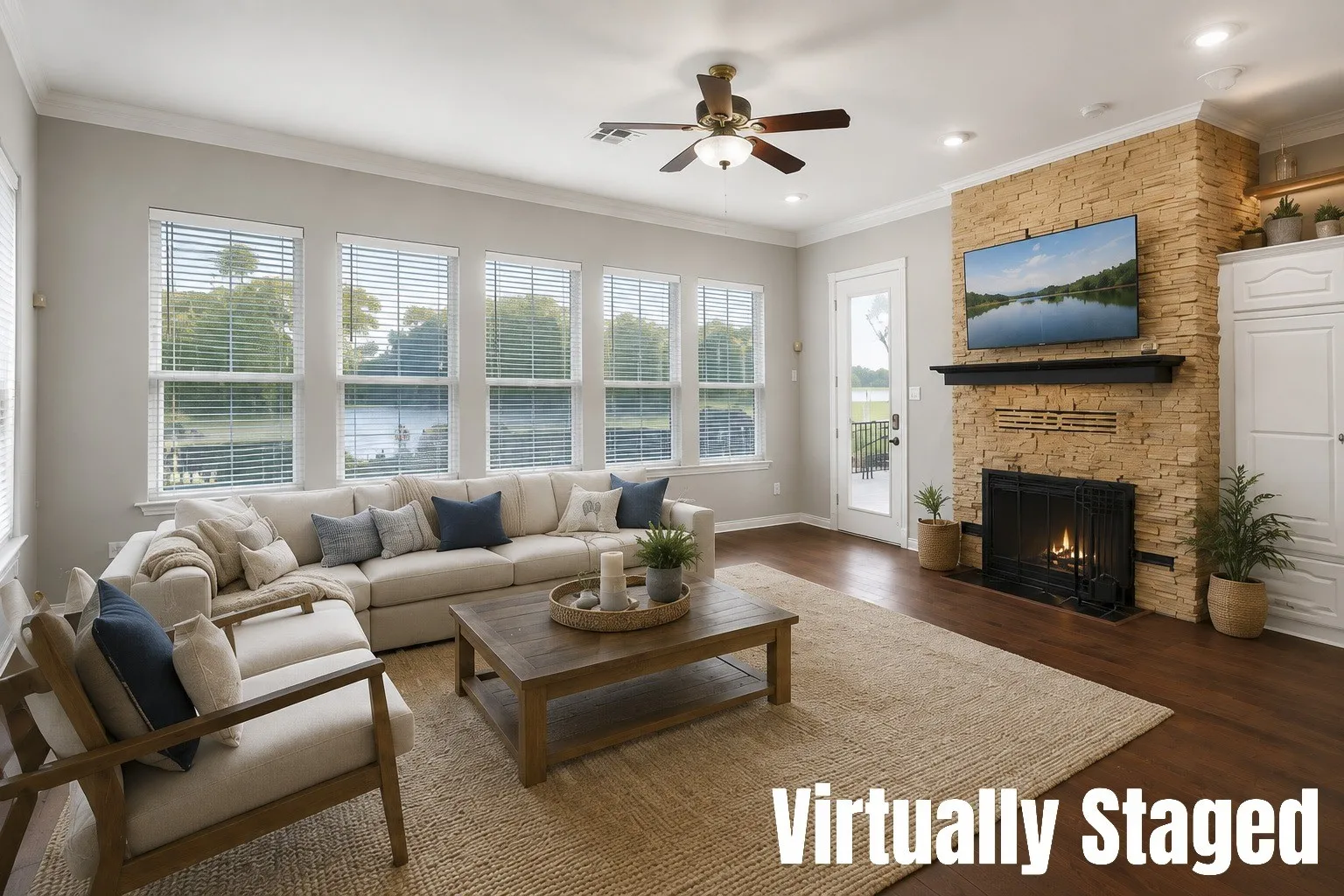 Engineered hardwood flooring, recessed lighting, ceiling fan, stacked stone fireplace with mantel, and built-in cabinetry