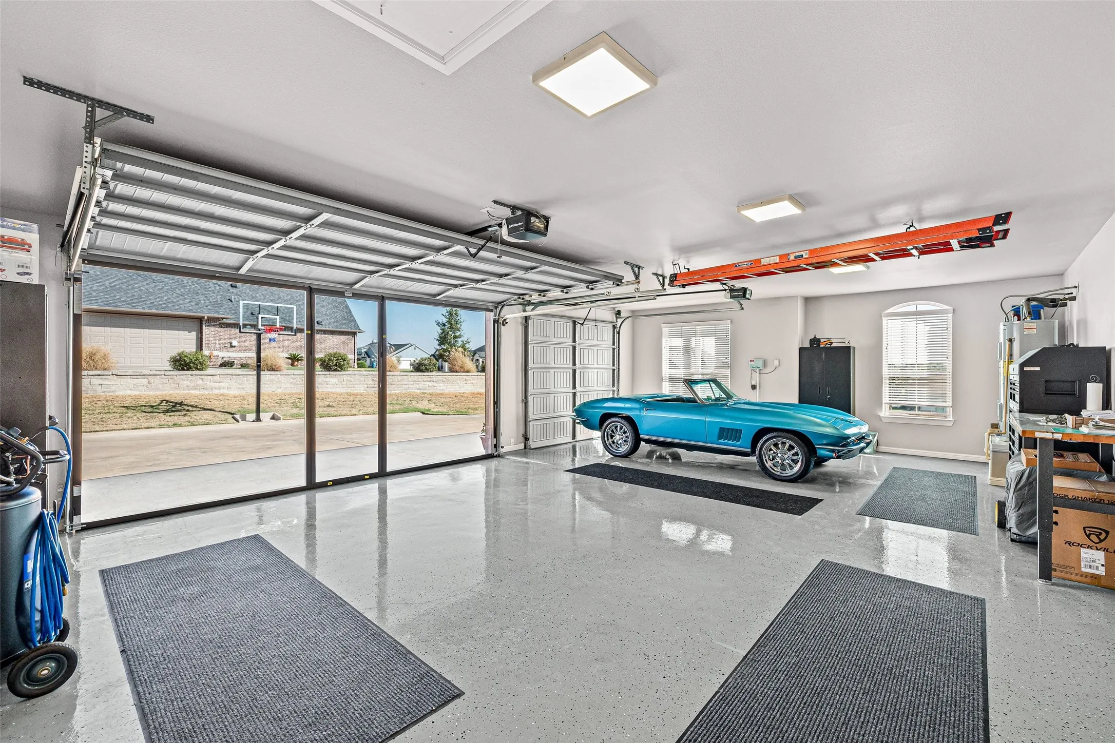 Garage with Epoxy floor and a pull down screen door.
