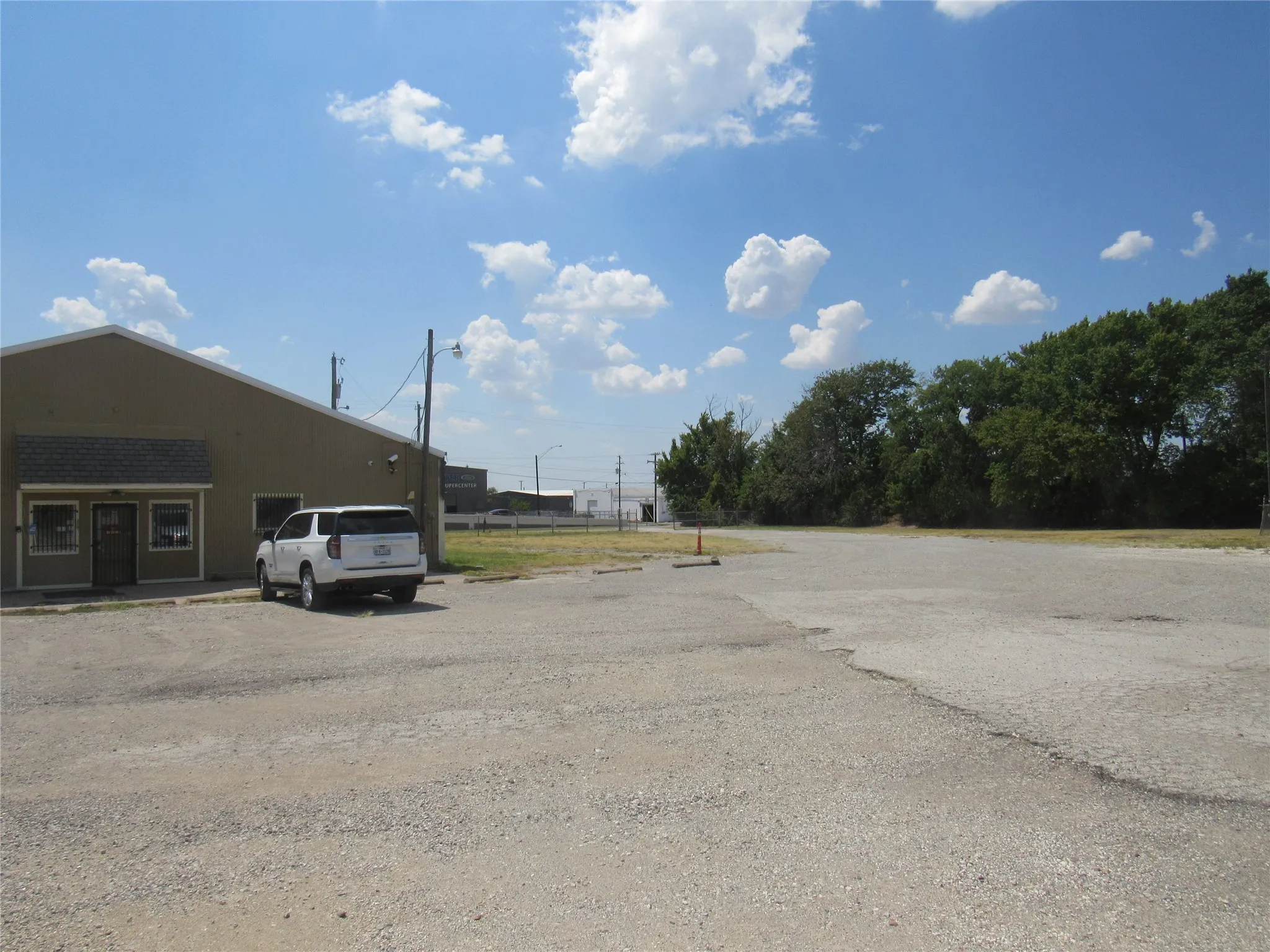 Commercial building with a neutral-toned exterior, gabled roofline, and multiple entry points