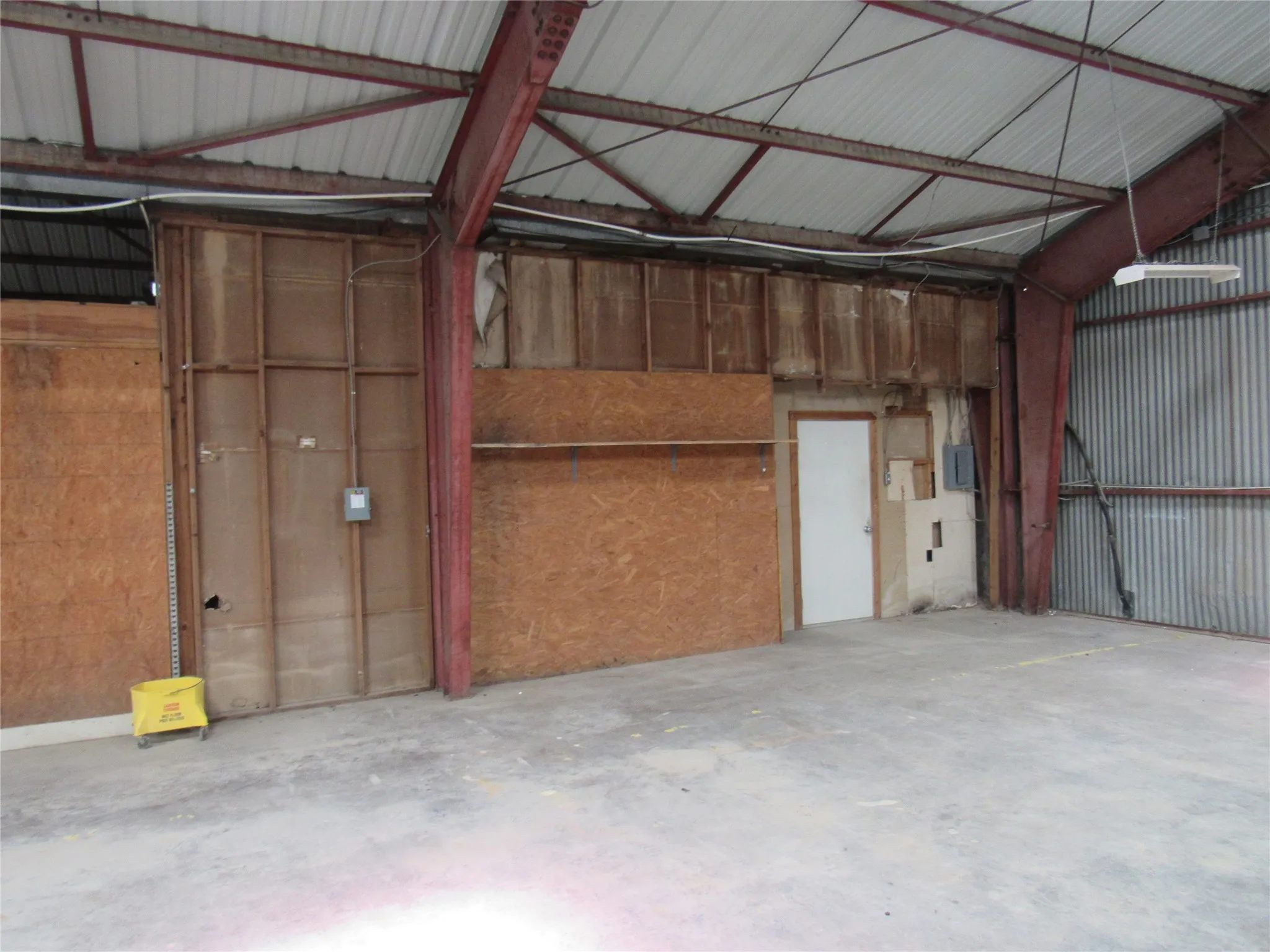 Metal frame construction with a corrugated roof and walls