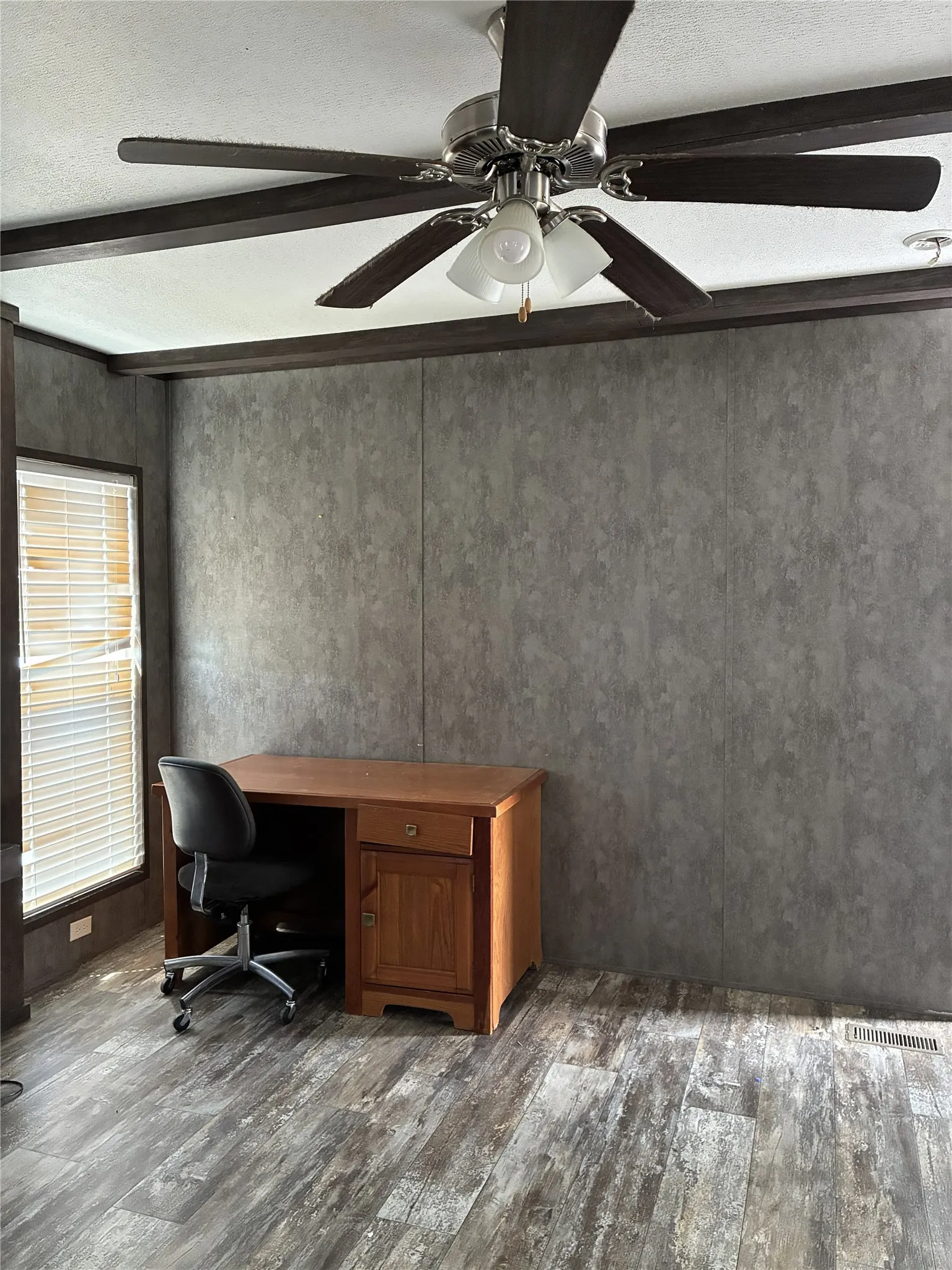 Wood-finish flooring with a ceiling fan light fixture