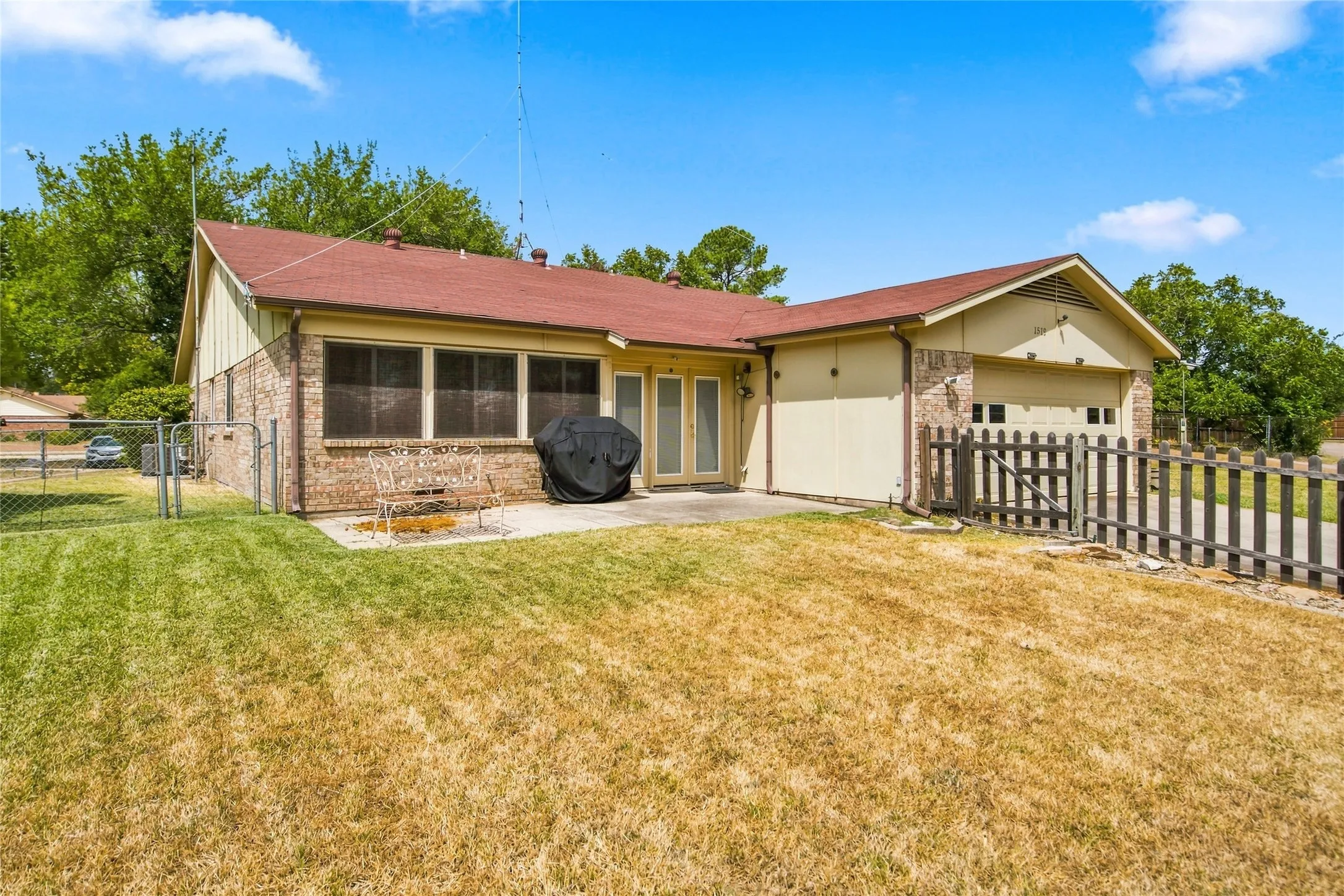 Backyard with patio area and rear entry garage.