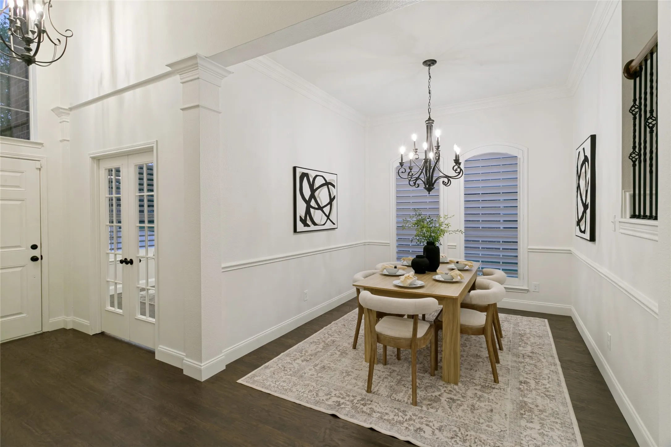 Wood-finish flooring throughout the space; dining directly off foyer could also serve as open office setting for dual home office spaces.
