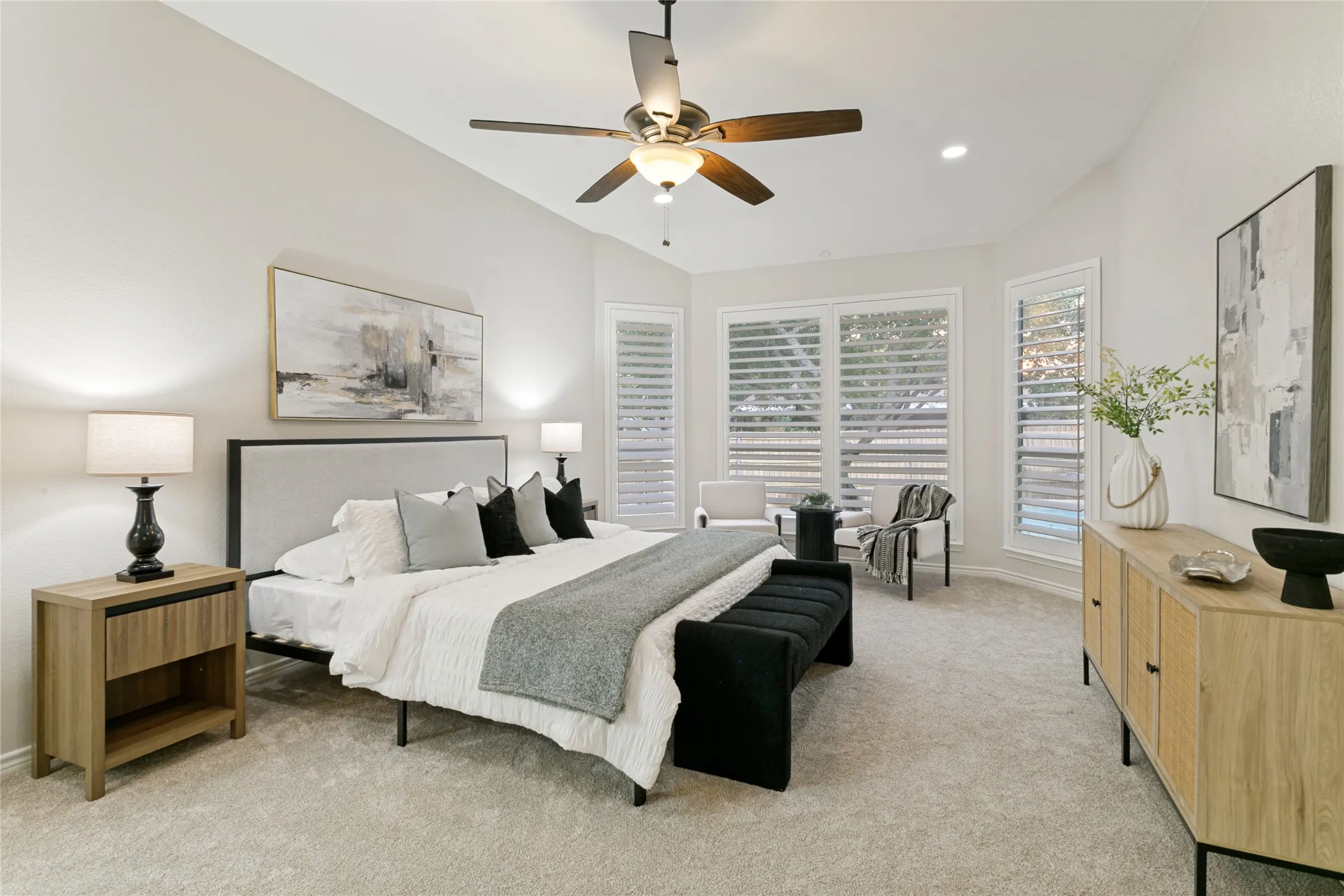 Vaulted ceilings, recessed lighting, and a ceiling fan