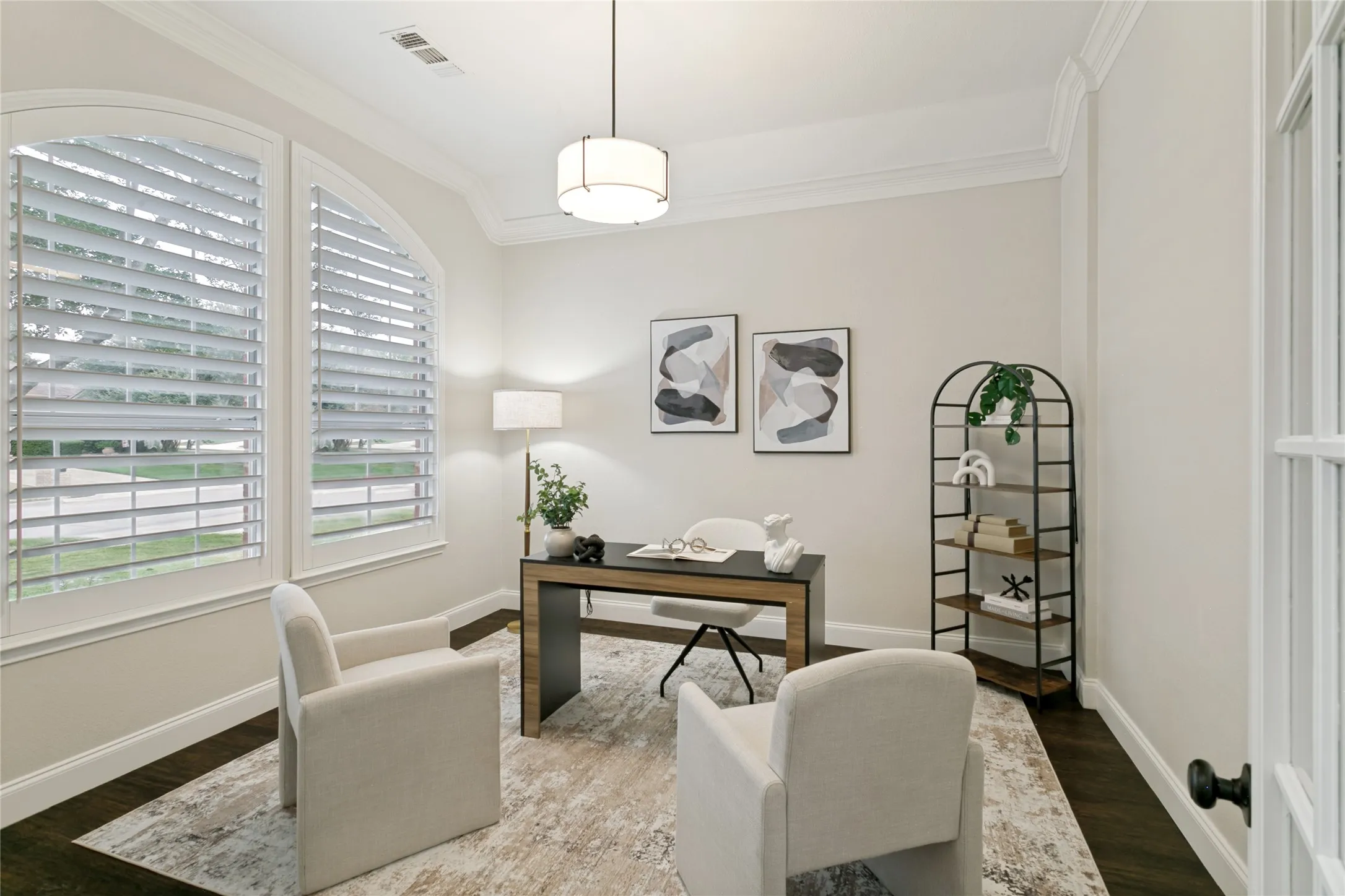 Arch-top windows with plantation shutters, dark wood-finish flooring, white crown molding, 10 ft ceiling,   a drum pendant light fixture, french doors.