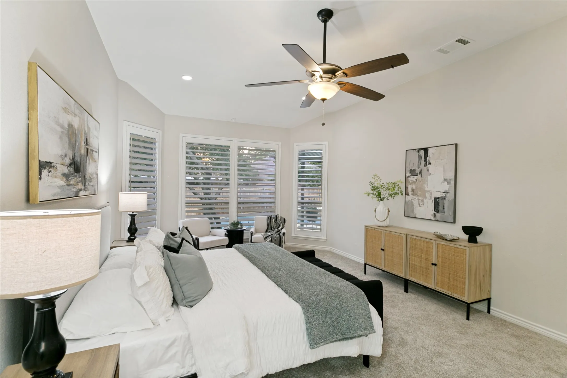 Vaulted ceiling, ceiling fan, recessed lighting, plantation shutters, and carpet flooring