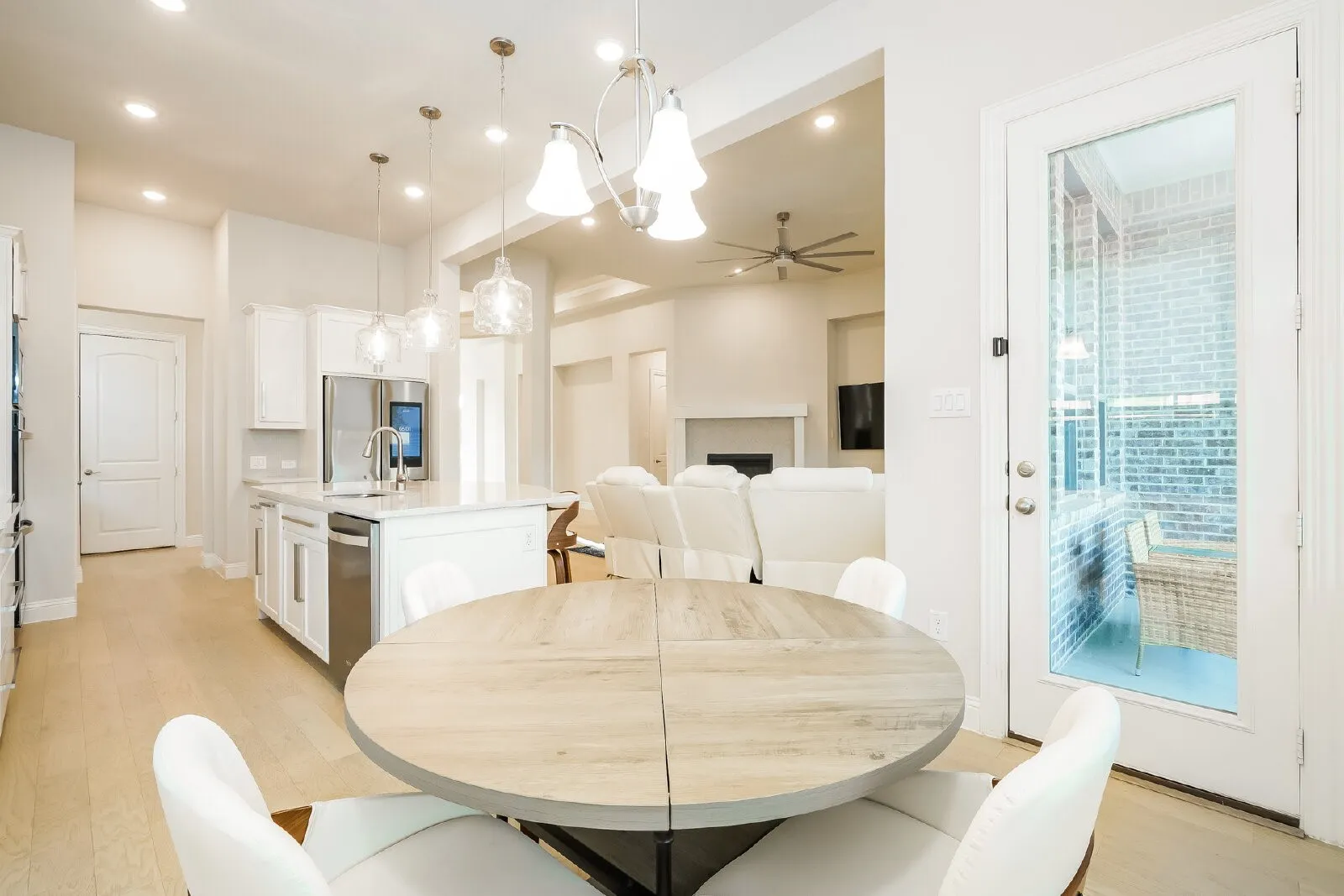 Kitchen featuring an island with built-in stainless steel appliances, recessed lighting, and pendant lights