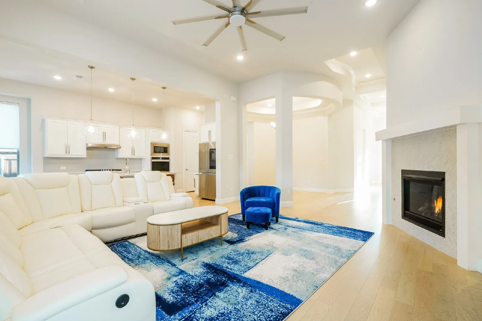 Recessed lighting, wood-finish flooring, and a ceiling fan