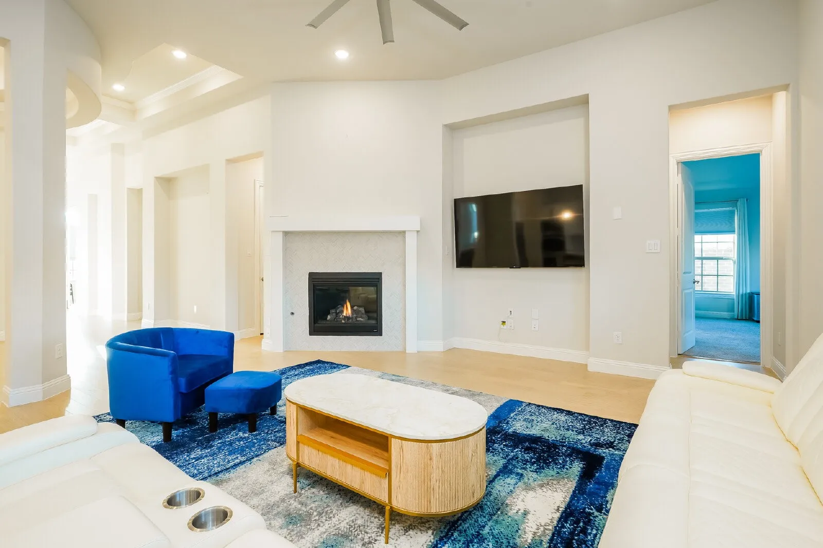 Living area with a fireplace, recessed lighting, and wood-finish flooring