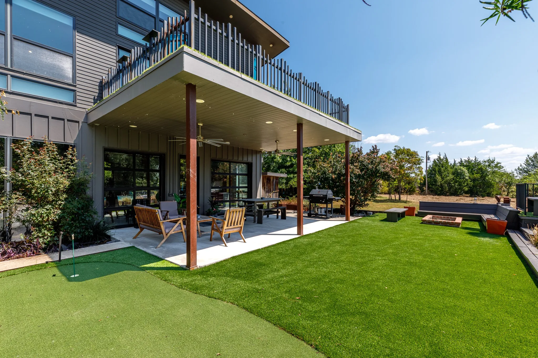 Ground-level patio with recessed lighting and ceiling fan, and 1 of 5 puttin greens