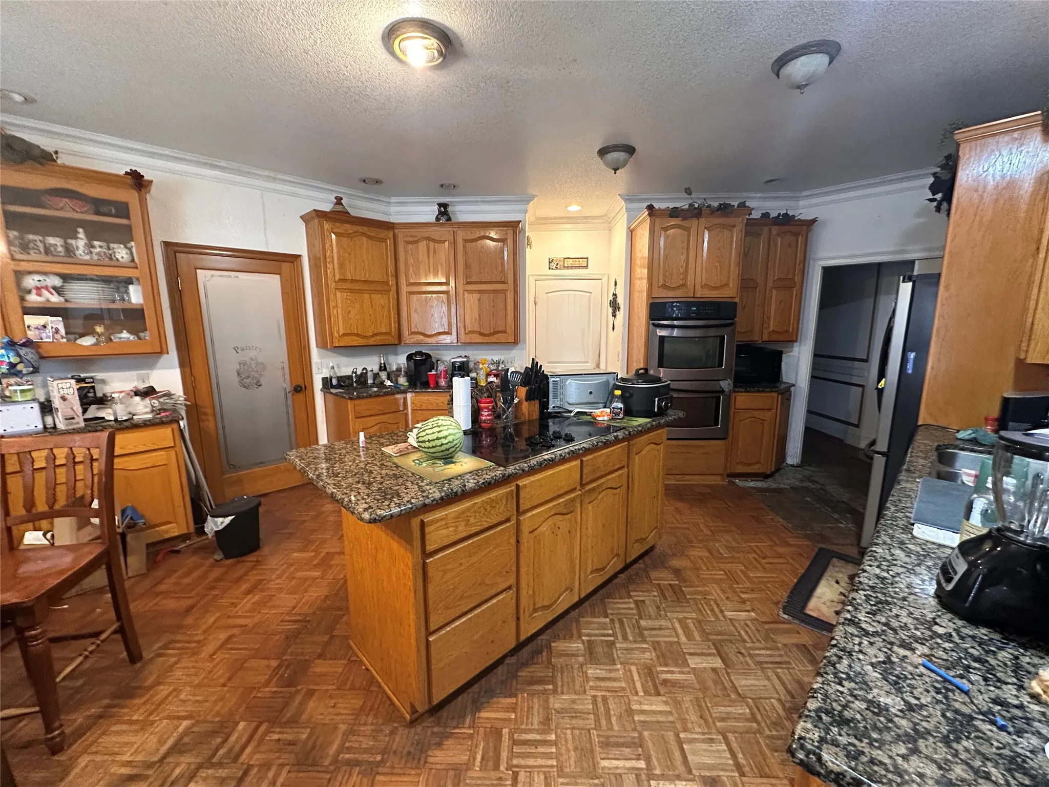 Wood-finish flooring throughout, complemented by wood cabinetry and granite countertops