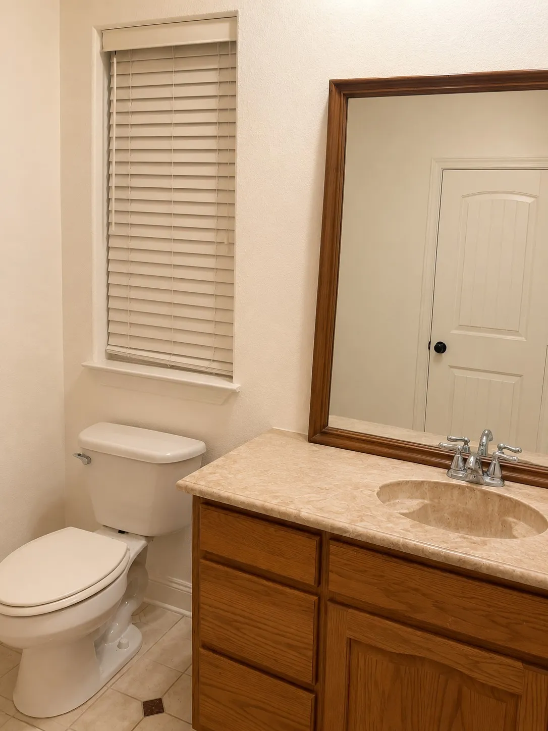 Vanity with a wood-finish cabinet, integrated sink, and chrome faucet