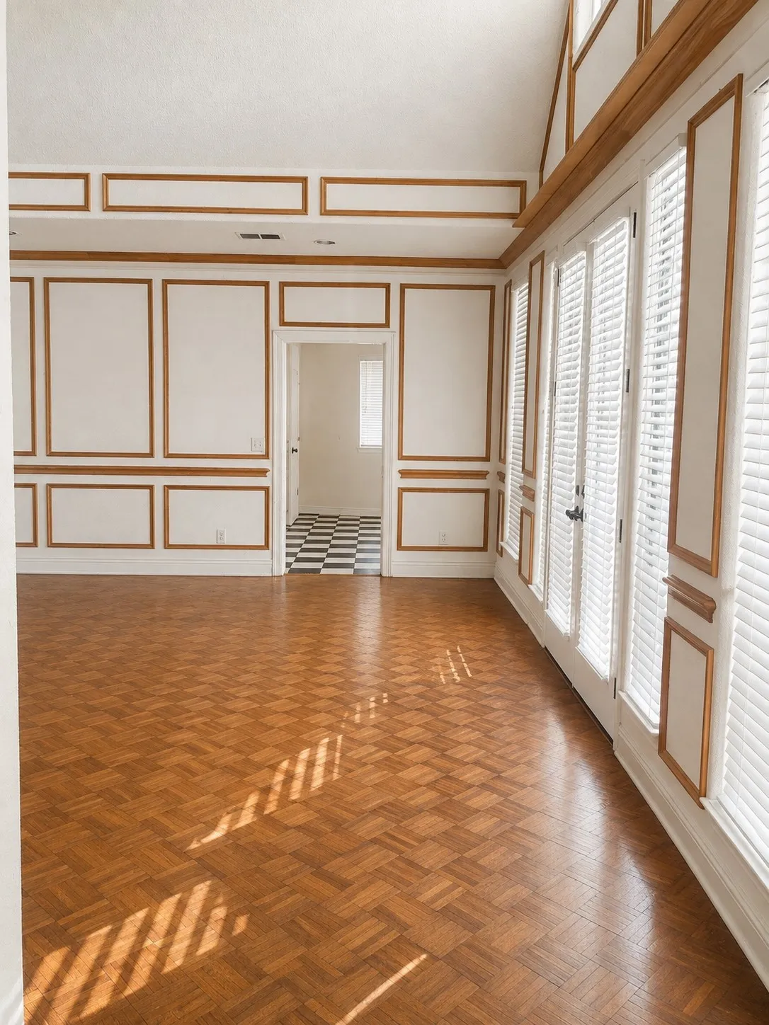 Parquet wood-finish flooring, paneled wall detailing, high ceilings, multiple French doors with louvered shutters, and an arched entry to an additional space