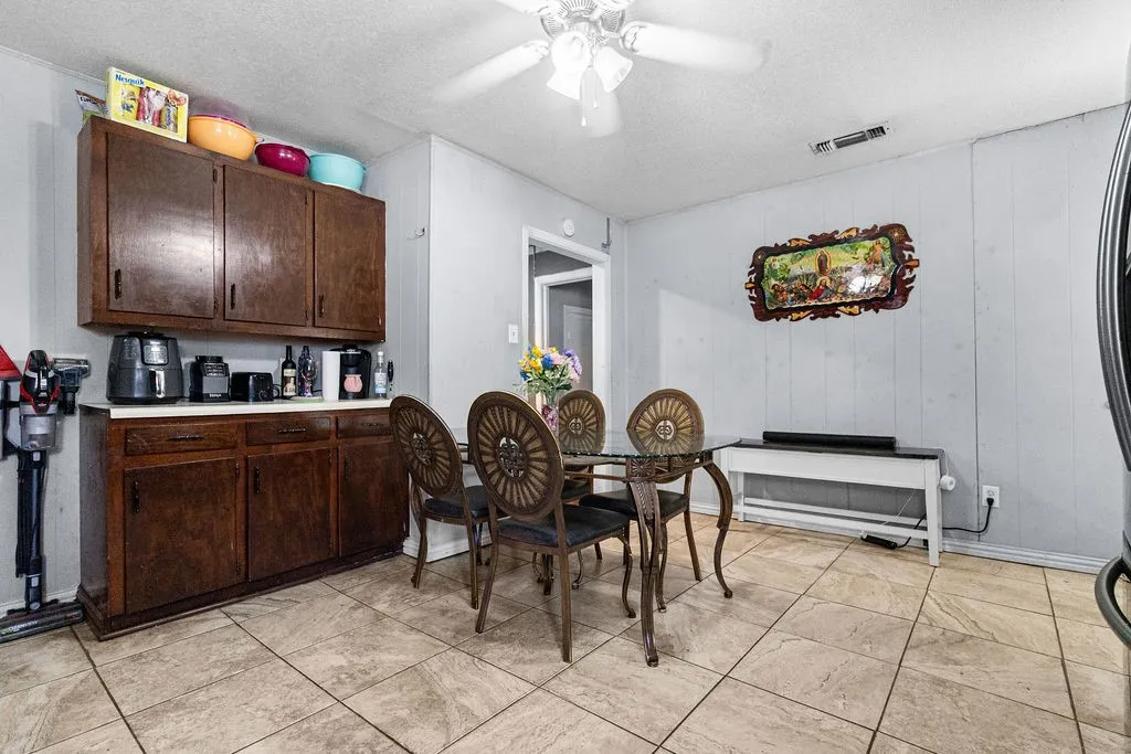 Tile flooring, wood cabinetry with white countertops, ceiling fan, and recessed lighting