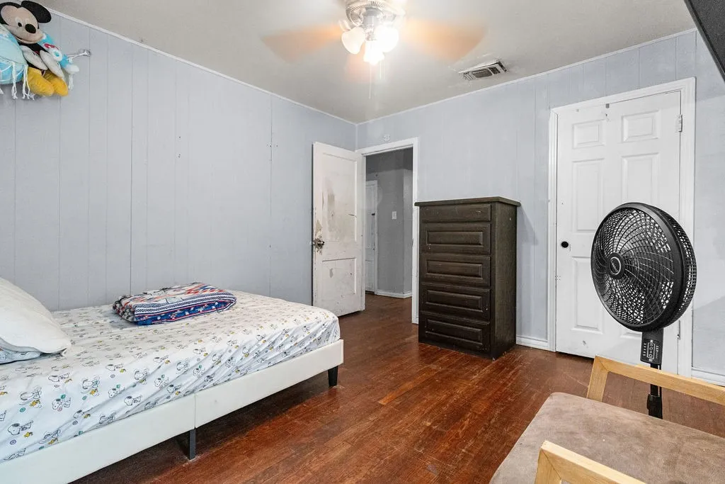 Wood-finish flooring with light-colored panel walls
