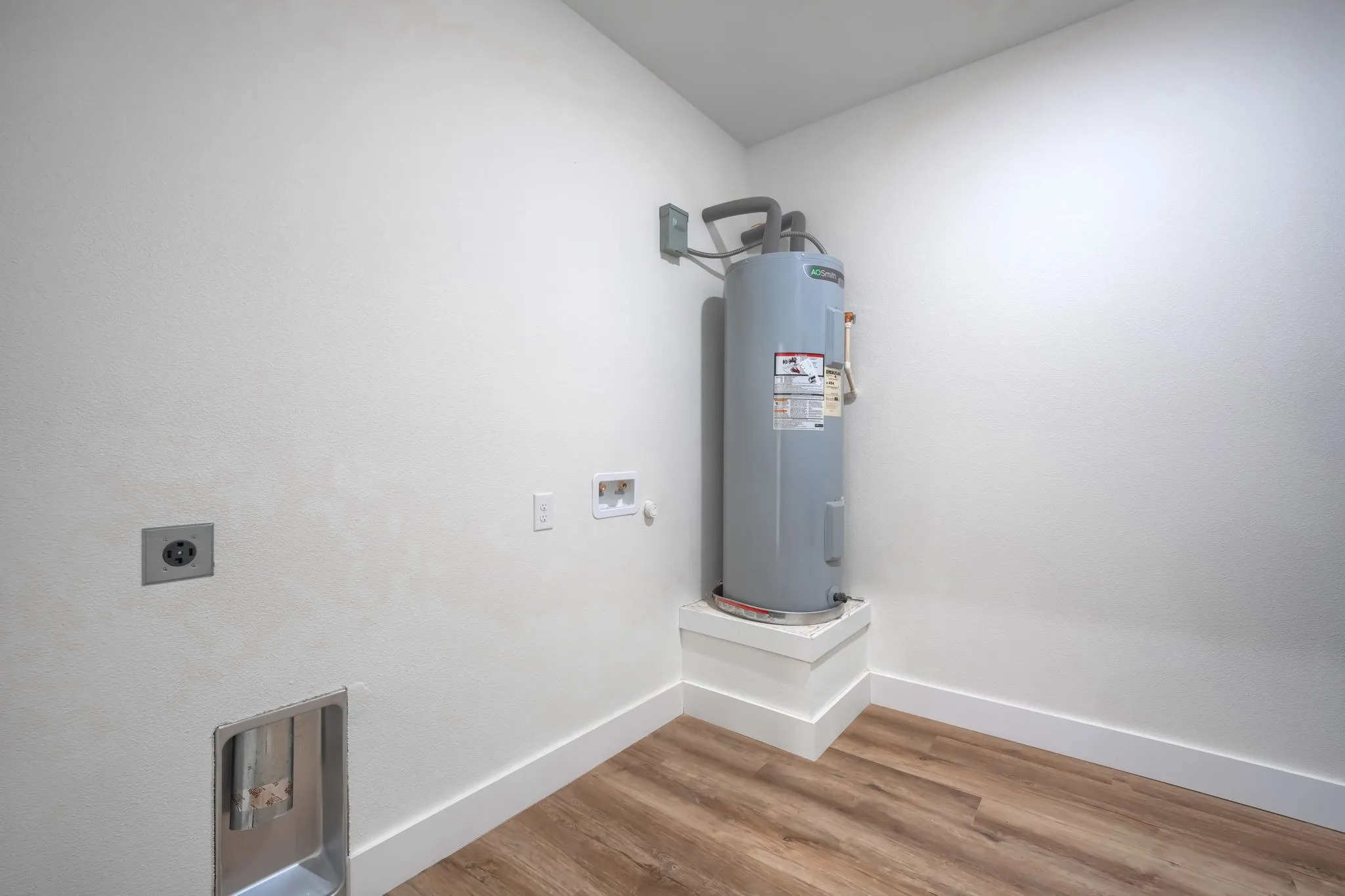 Water heater installation, wood-finish flooring, and white walls