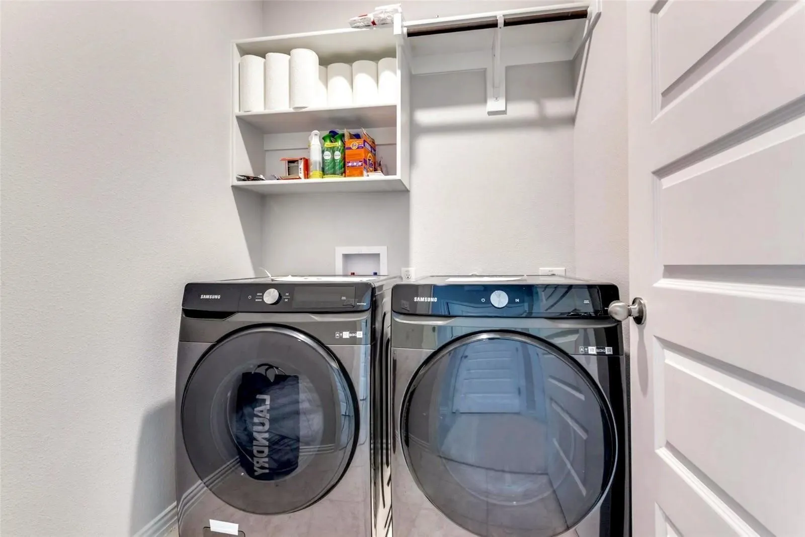 Built-in shelving and a clothing rod provide organized storage