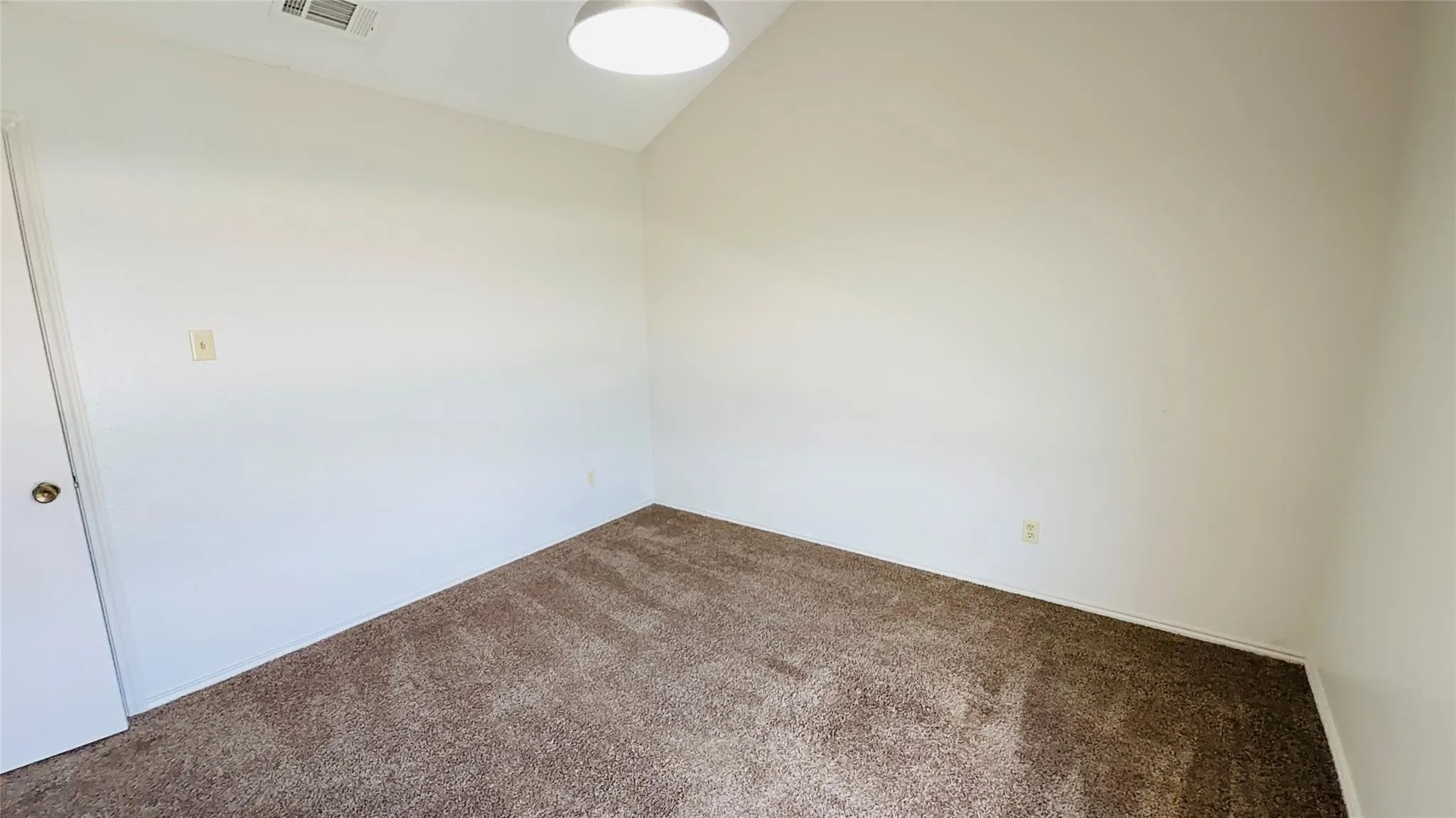 Recessed lighting, sloped ceiling, light-colored walls, and brown carpet flooring