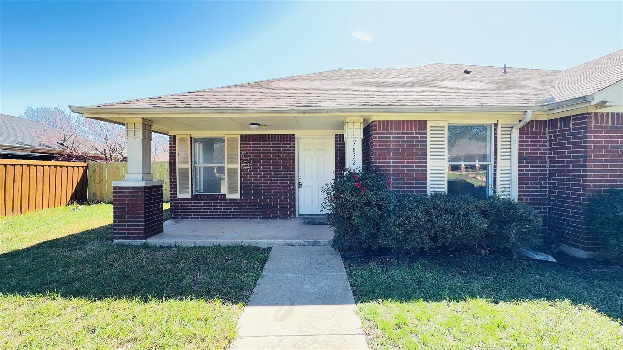 Brick exterior with a covered porch entry