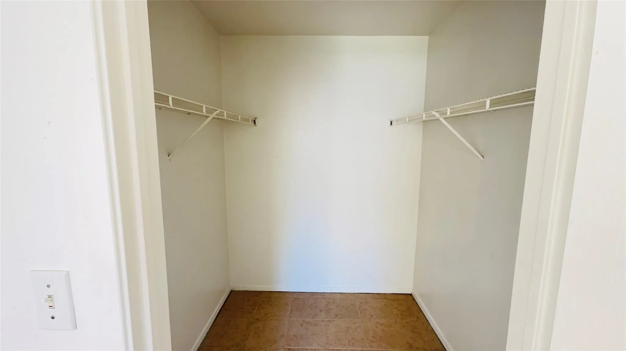 Built-in closet with wire shelving and durable flooring