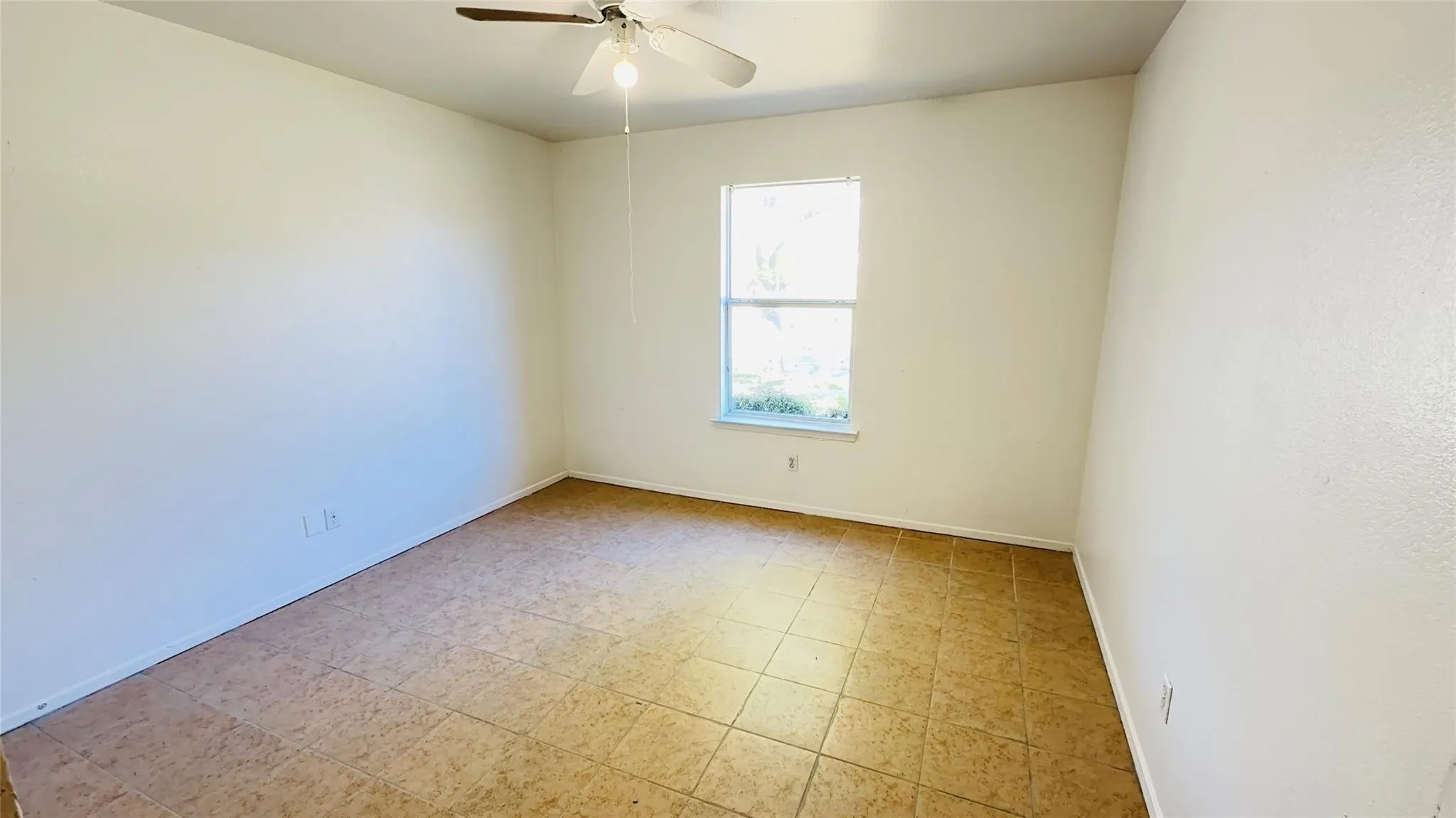 Recessed window with white trim, ceiling fan with integrated lighting, and tile flooring