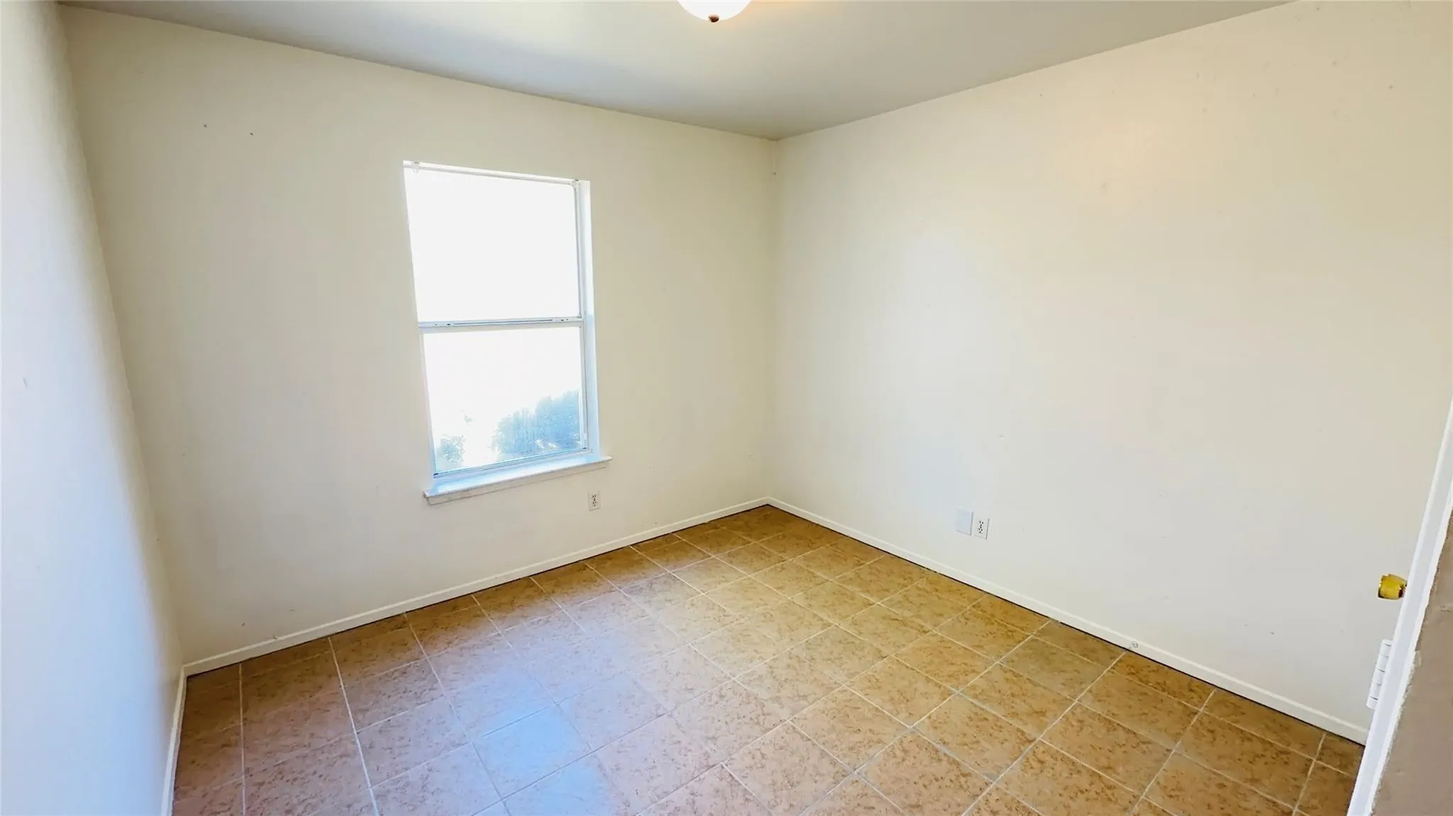 Single pane window and tile flooring