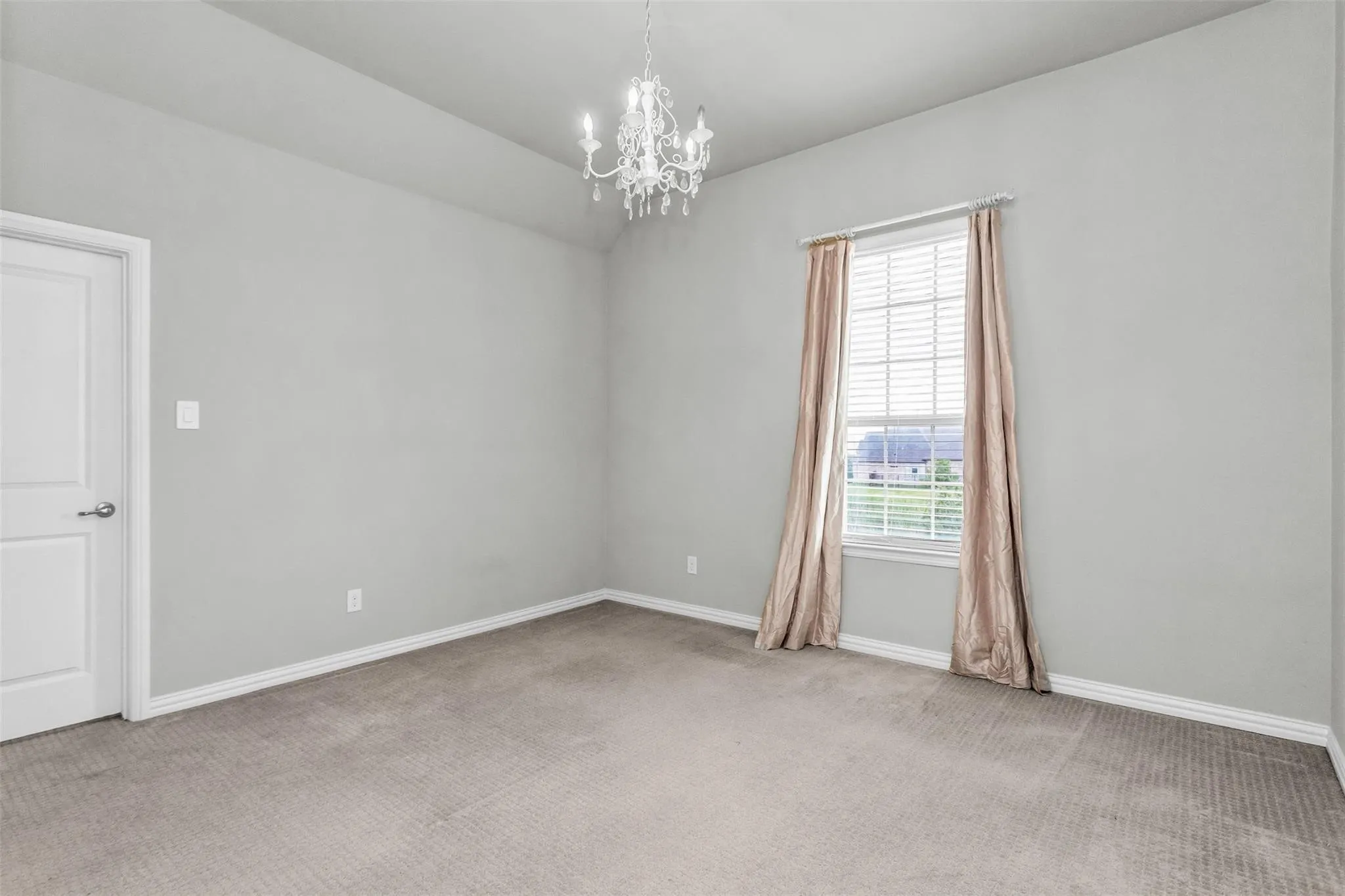 Neutral paint finish, recessed ceiling, chandelier lighting, carpeted flooring, and a window with blinds