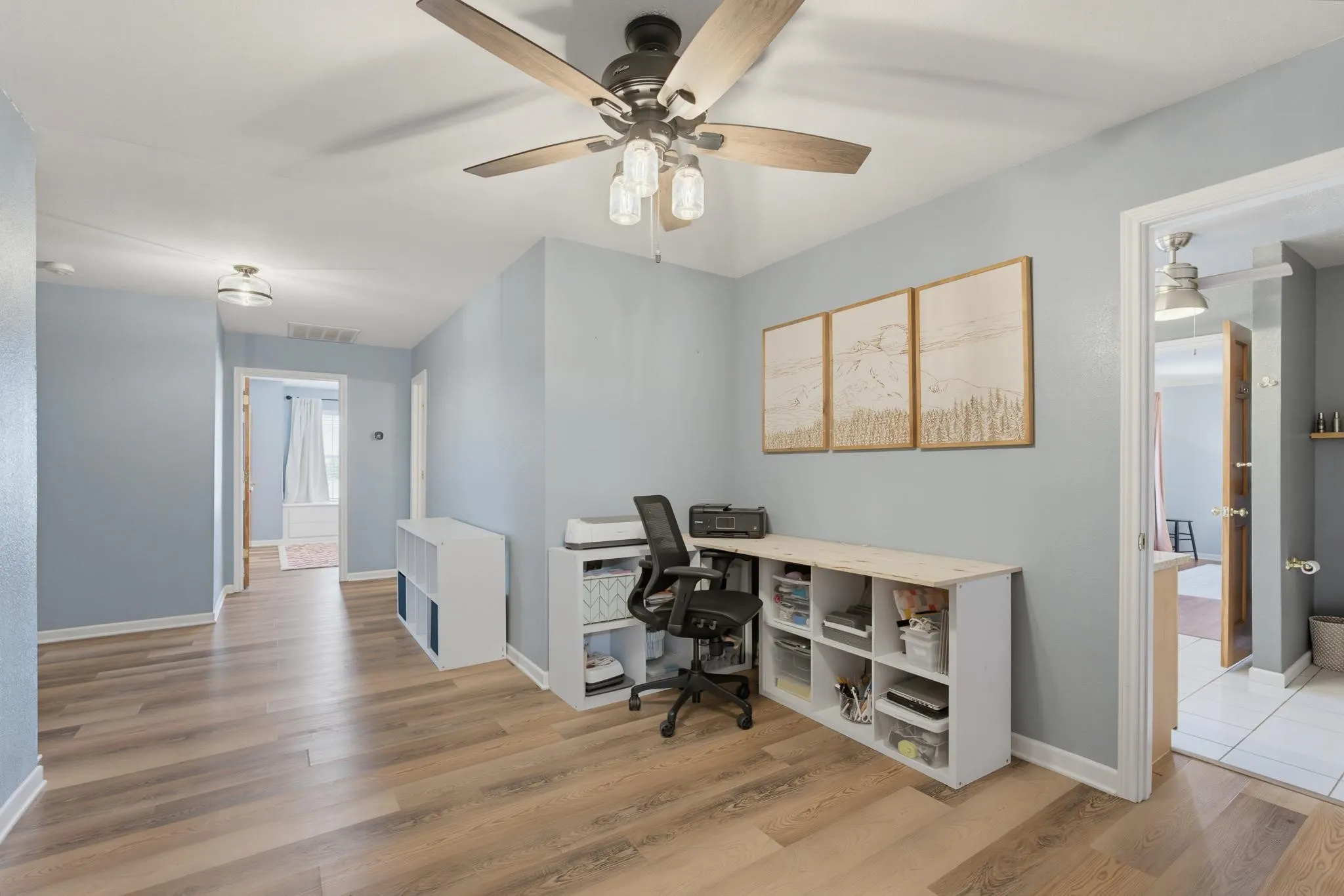 Community hallway with integrated lighting, and built-in shelving with a wood-finish countertop