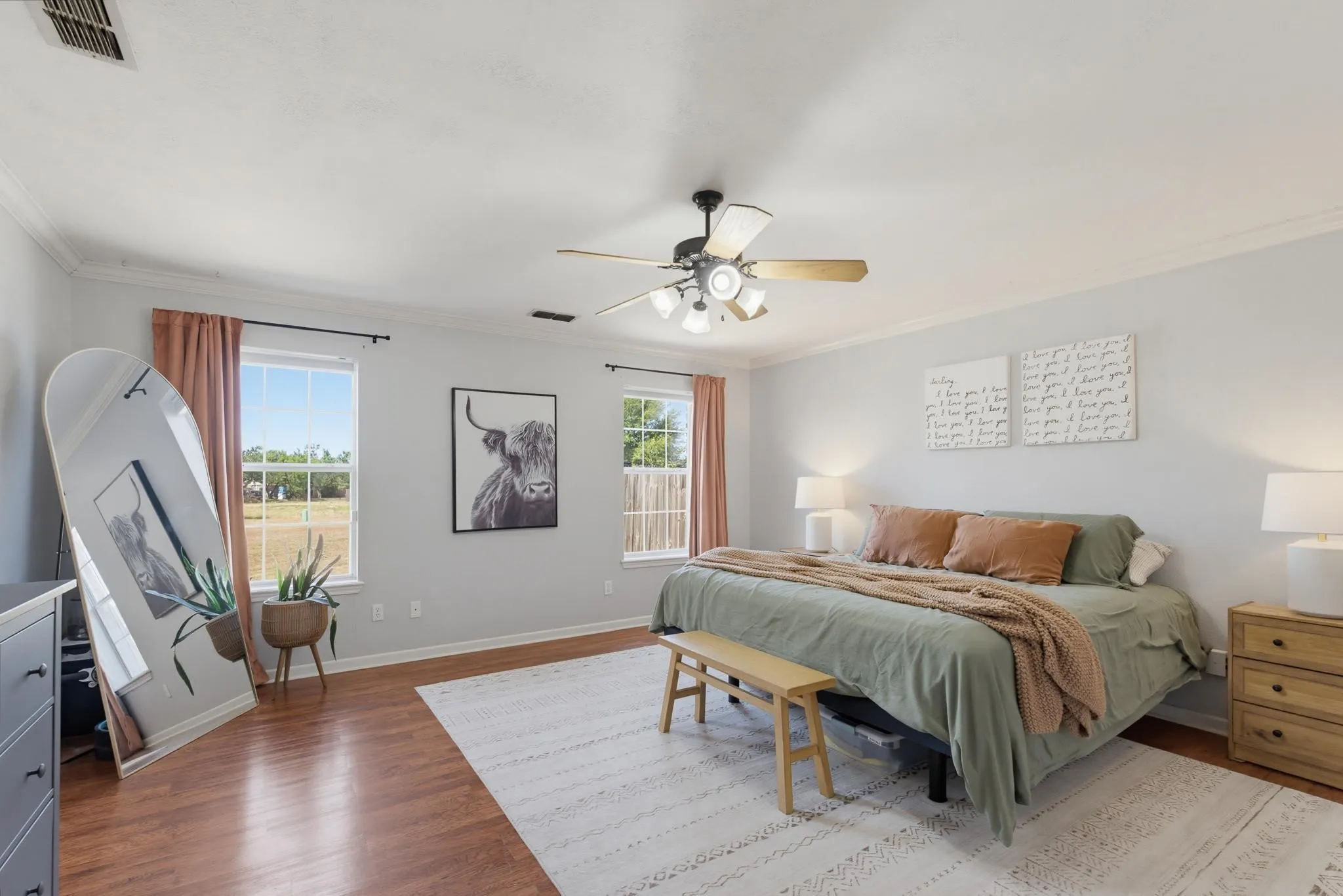 Hardwood-finish flooring, white walls, and a ceiling fan with integrated lighting