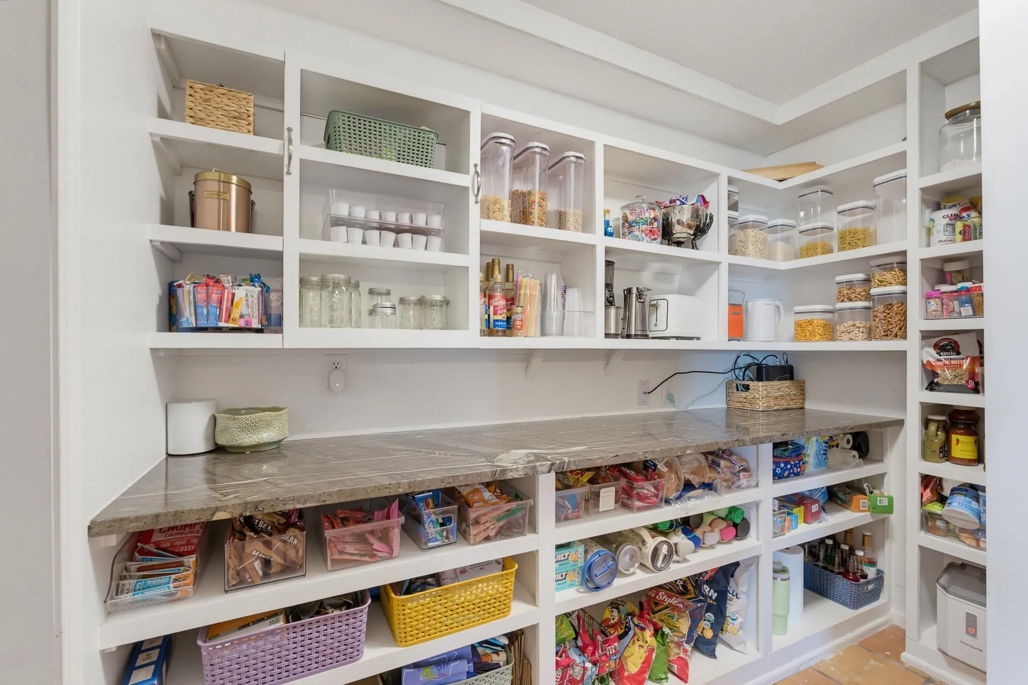 Built-in white shelving providing extensive storage