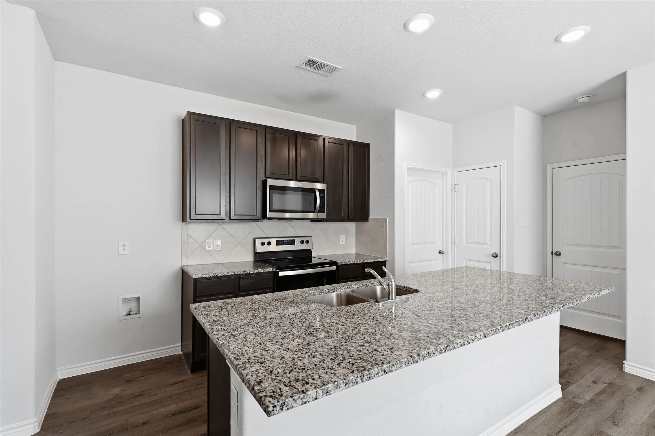 Granite Counters, pantry and full sized utility room at 8020 Flora Drive listed  by Seth Fowler of Williams Trew Real Estate