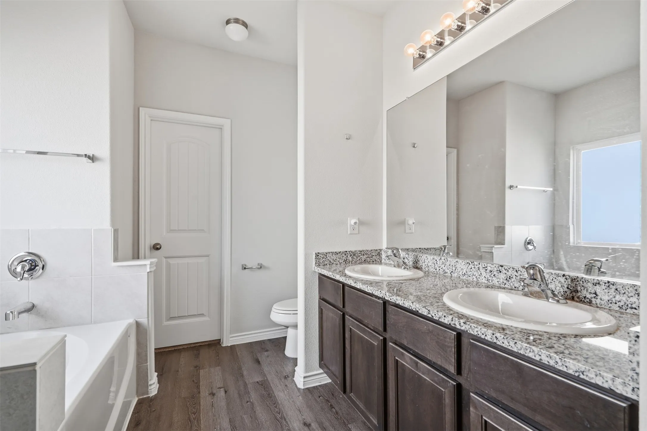 Double sinks, granite counters, large closet in the primary master bathroom at 8020 Flora Drive listed by Seth Fowler of Williams Trew Real Estate