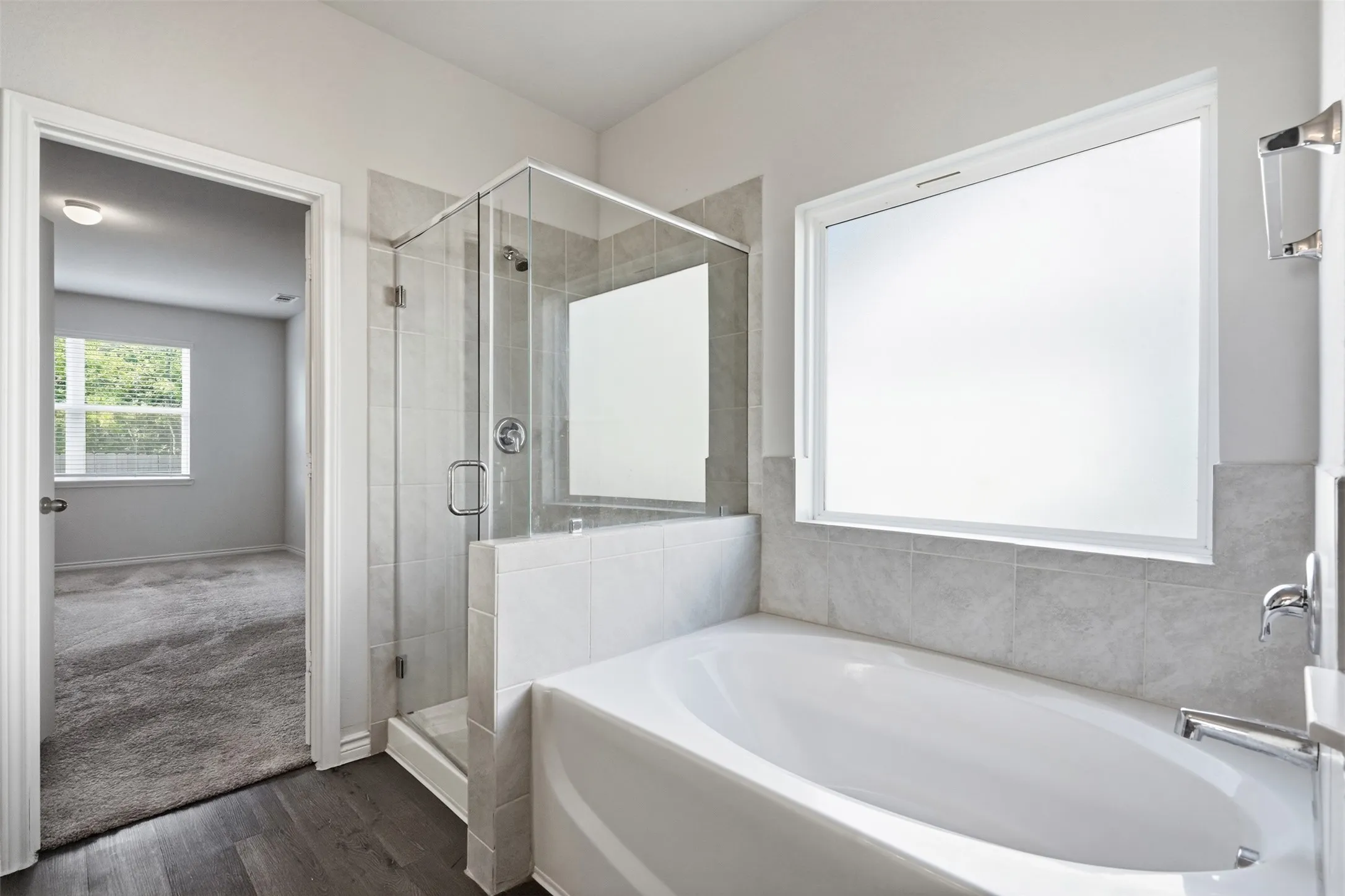 Soak your cares away in the deep tub in the primary master bathroom at 8020 Flora Drive listed by Seth Fowler of Williams Trew Real Estate