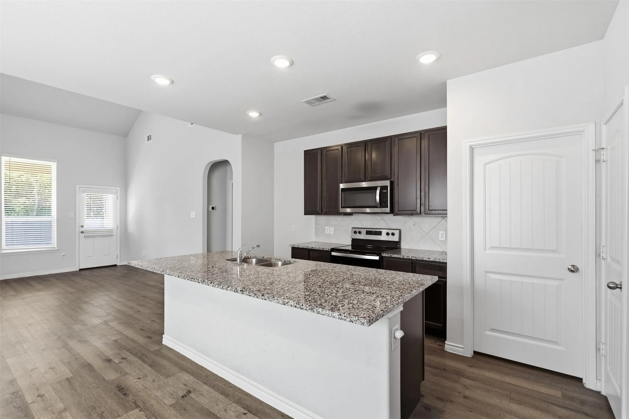 Granite counters, eat-in kitchen, open floor plan at 8020 Flora Drive listed  by Seth Fowler of Williams Trew Real Estate